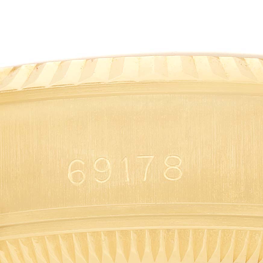 The image shows a close-up of the side of a Rolex President 69178 Women's Yellow Gold Champagne Dial watch, focusing on the model number engravings.