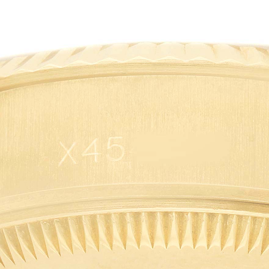 The image shows a close-up of the edge and engraved side of a Rolex President 69178 Women's Yellow Gold Champagne Dial watch bezel.