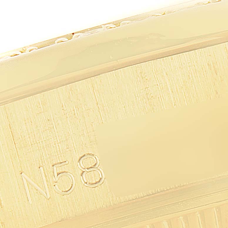 The close-up shows a side view of the case of a Rolex President 69158 Women's Yellow Gold Grey Dial 69158 Women's Yellow Gold Grey Dial model watch with part of its serial number visible.