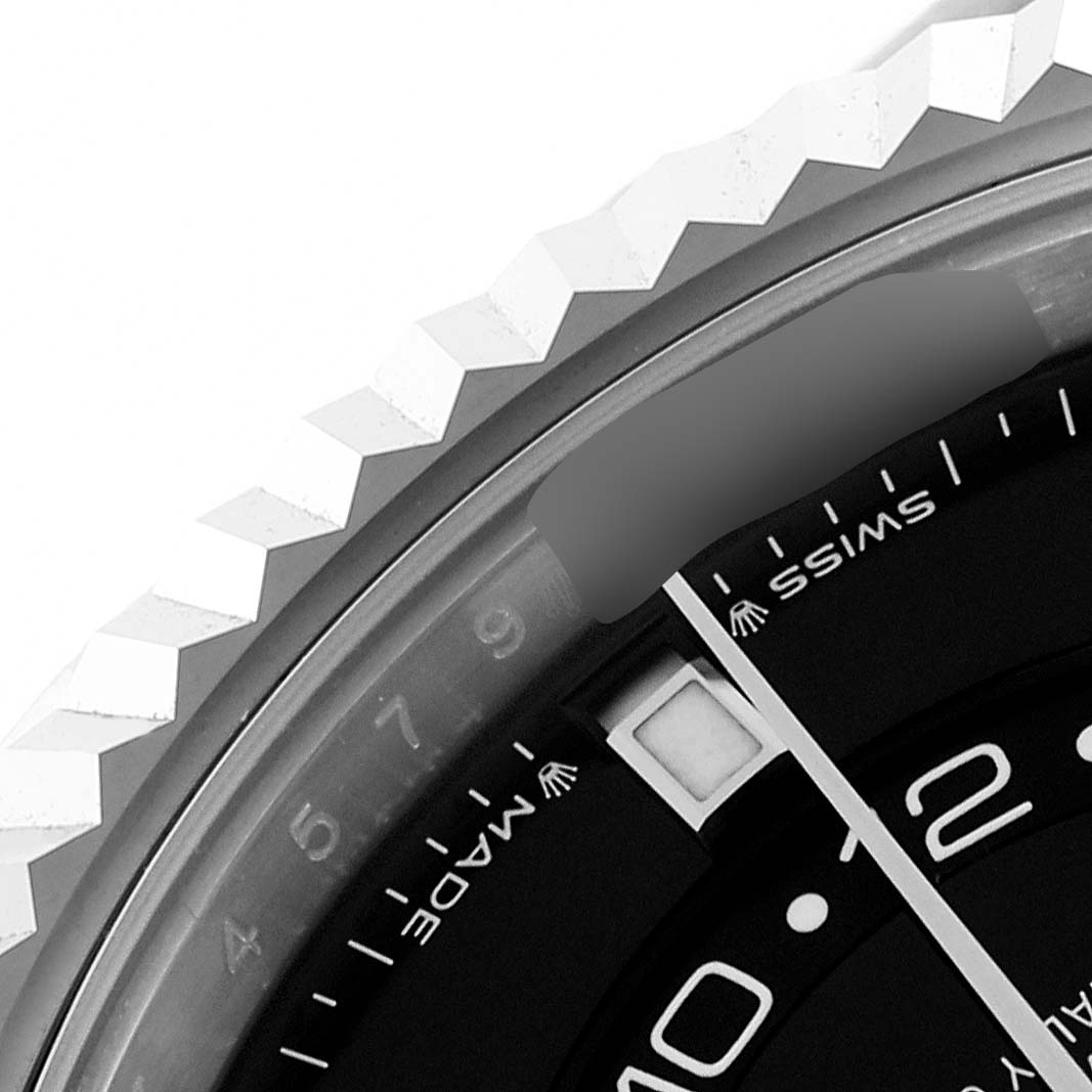 The image shows a close-up of the Rolex Sky-Dweller 336239-0002 Men's White Gold Black Dial 336239-0002 Men's White Gold Black Dial's bezel, part of the dial, and the "Swiss Made" text.