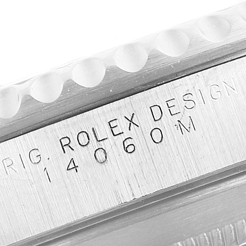 This image shows a close-up of the engraved case side of a Rolex Submariner 14060M Men
s Stainless Steel Black Dial 14060M Men
s Stainless Steel Black Dial model.
