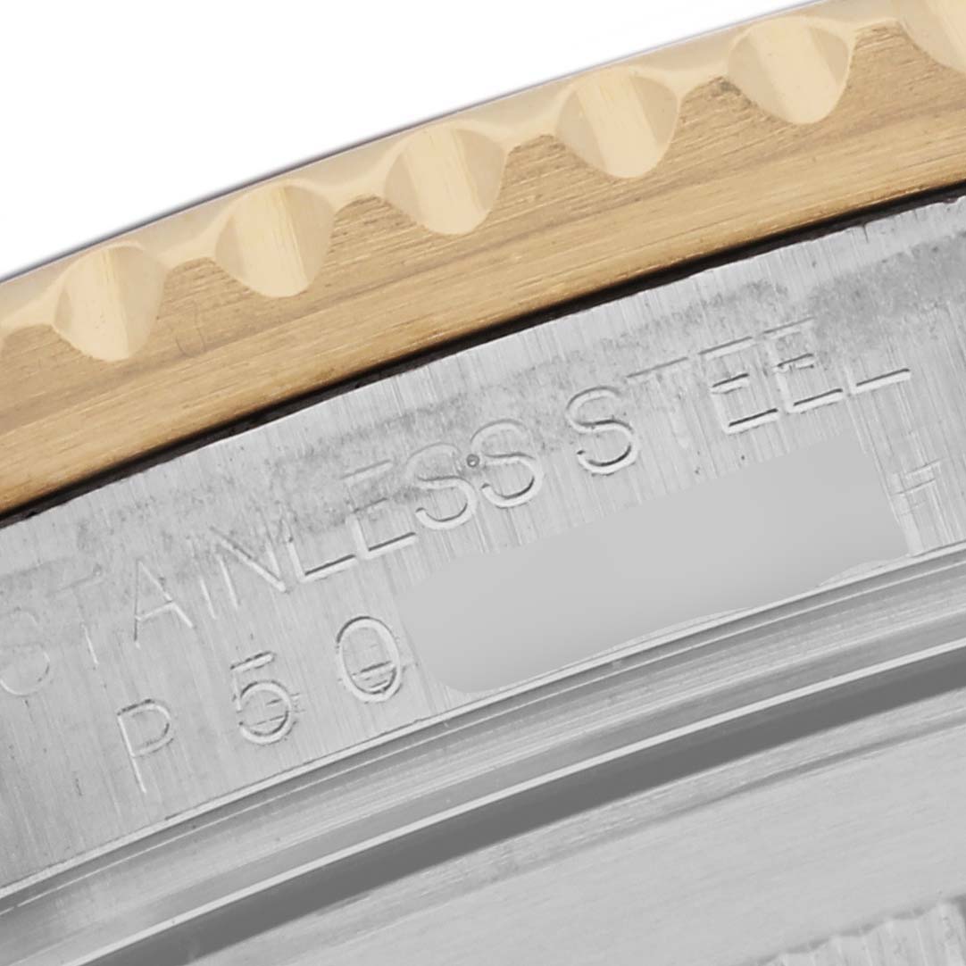 The image shows a close-up angled view of the Rolex Submariner 16613 Men's Steel and Gold (two tone) Black Dial 16613 Men's Steel and Gold (two tone) Black Dial's stainless steel case back and bezel edge.