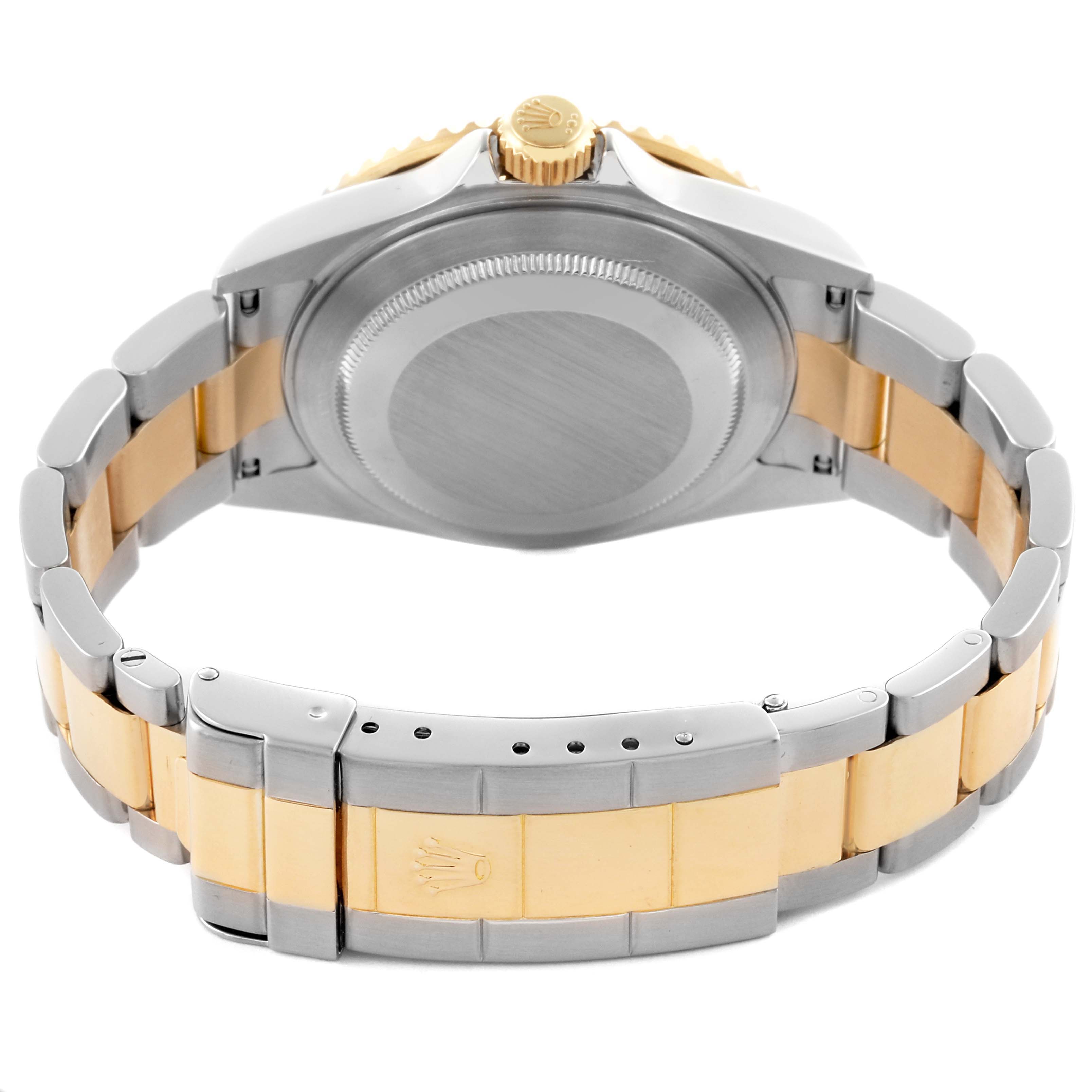 The image shows the back view of a Rolex Submariner 16613 Men's Steel and Gold (two tone) Blue Dial 16613 Men's Steel and Gold (two tone) Blue Dial, highlighting the case and gold-silver bracelet.