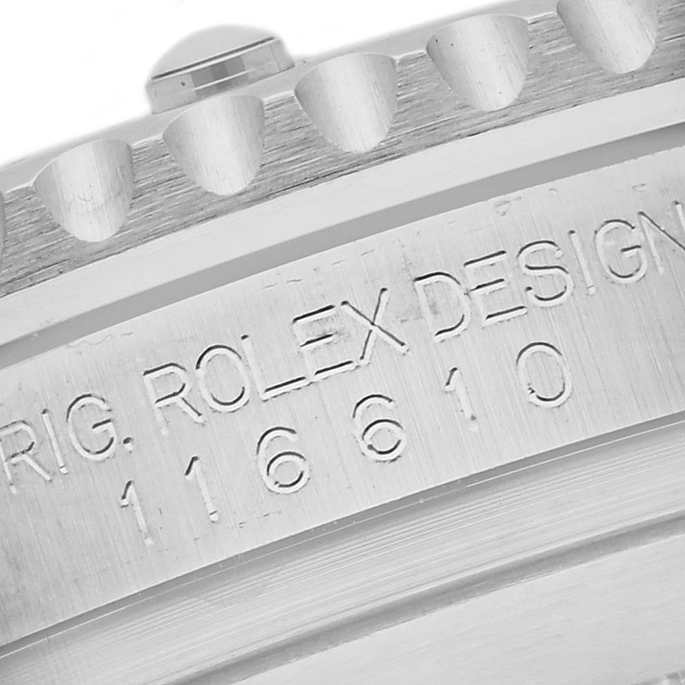 The image shows a close-up of the Rolex Submariner 116610LN Men's Stainless Steel Black Dial 116610LN Men's Stainless Steel Black Dial's bezel edge and case side with engraved text.