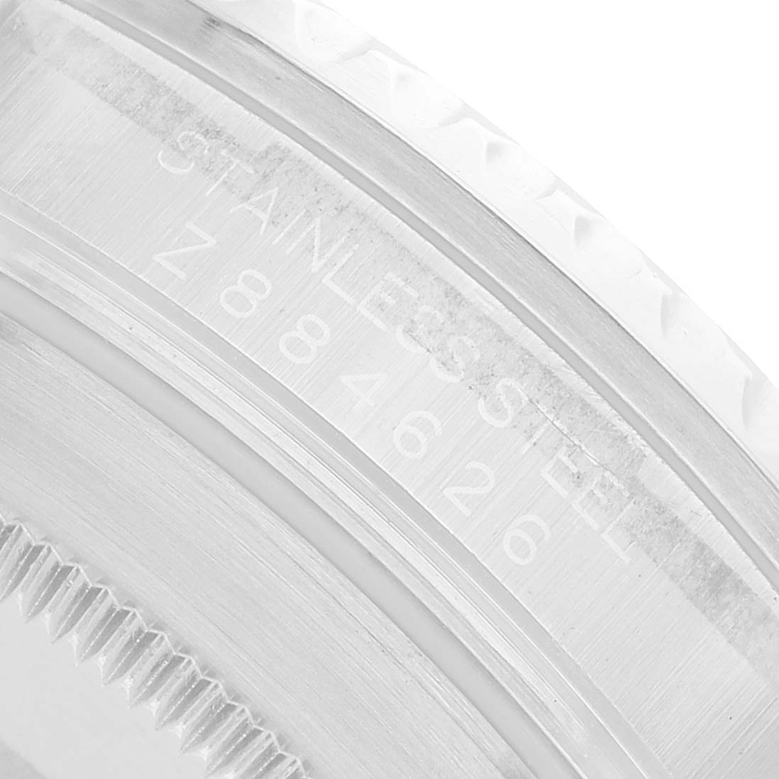 The image shows a close-up of the edge and engravings on the bezel of a Rolex Submariner 16610 Men's Stainless Steel Black Dial.