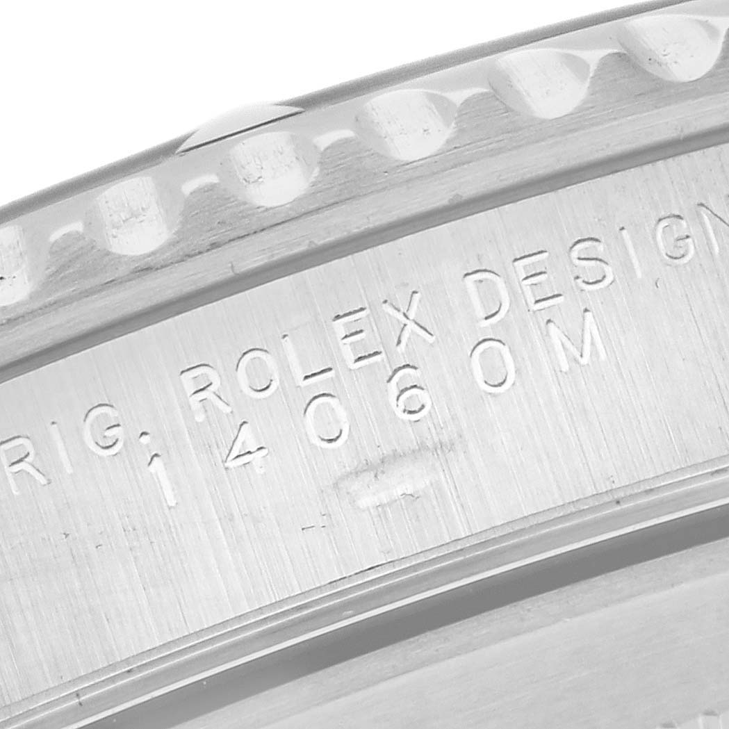 This image shows a close-up of the side and engraved details on a Rolex Submariner 14060M Men's Stainless Steel Black Dial 14060M Men's Stainless Steel Black Dial watch case.