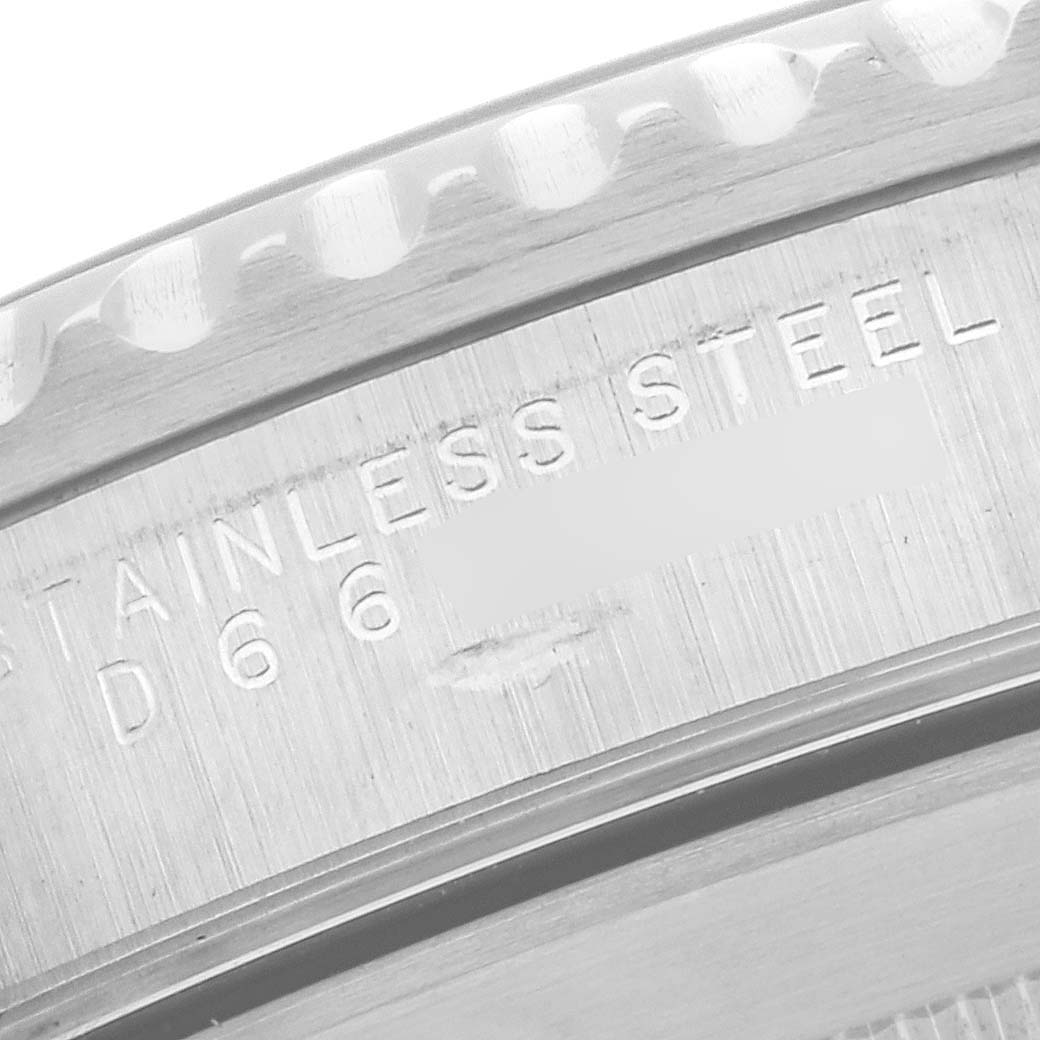 The image shows a close-up of the edge of the stainless steel case back of a Rolex Submariner 14060M Men's Stainless Steel Black Dial 14060M Men's Stainless Steel Black Dial, featuring engraved text.
