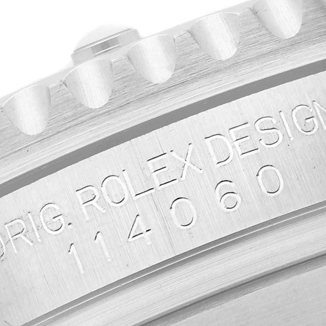 The image shows a close-up of the Rolex Submariner 114060 Men's Stainless Steel Black Dial 114060 Men's Stainless Steel Black Dial's engraved side case, highlighting the model number and design details.