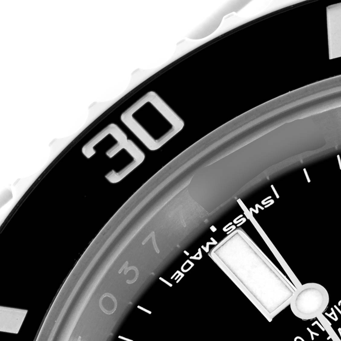 The image shows a close-up of the bezel and part of the dial of the Rolex Submariner 114060 Men's Stainless Steel Black Dial 114060 Men's Stainless Steel Black Dial watch.
