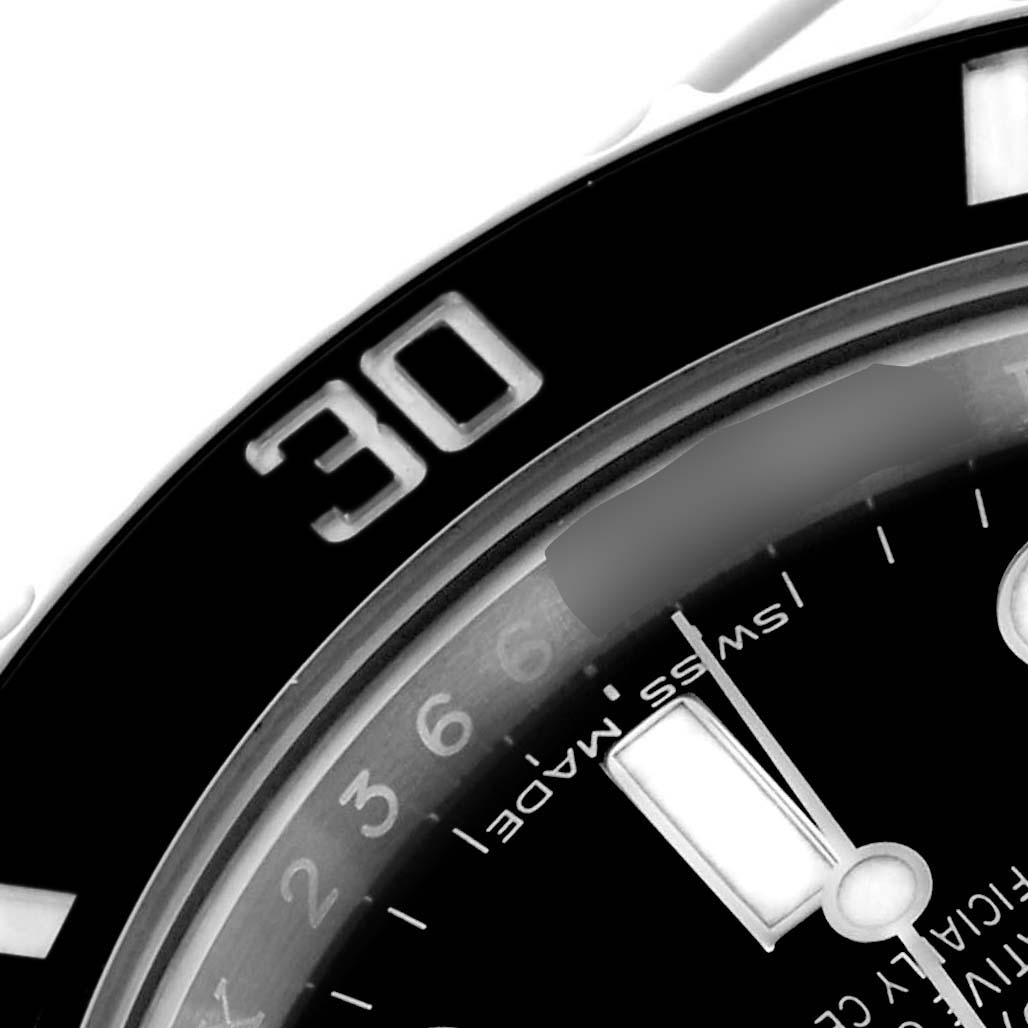 The image shows a close-up of the bezel and part of the dial of a Rolex Submariner 114060 Men's Stainless Steel Black Dial 114060 Men's Stainless Steel Black Dial watch.