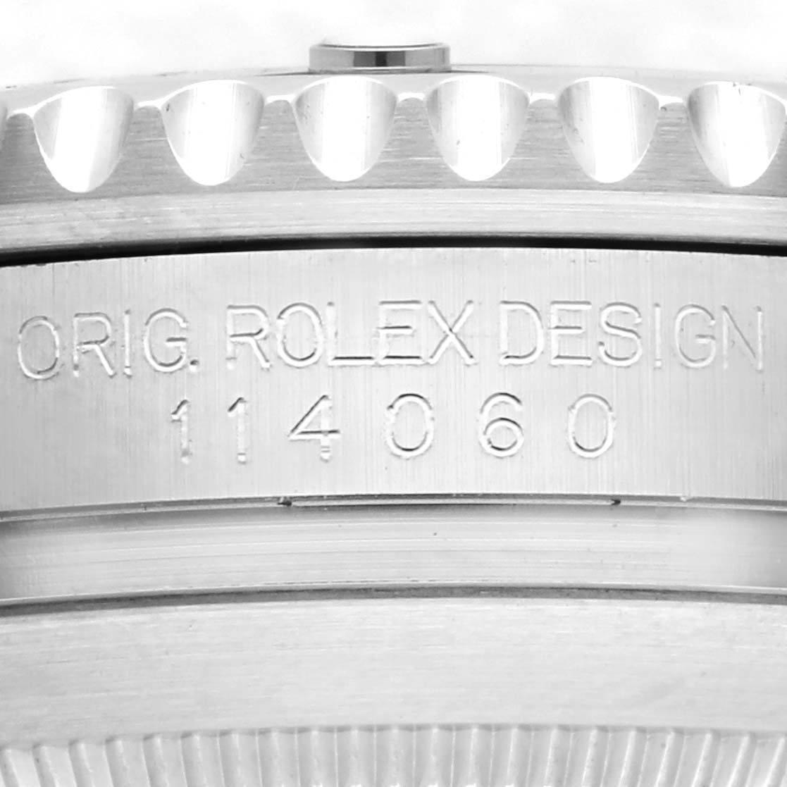 The image shows the side view of a Rolex Submariner 114060 Men's Stainless Steel Black Dial 114060 Men's Stainless Steel Black Dial, highlighting the engraved model number and design markings.