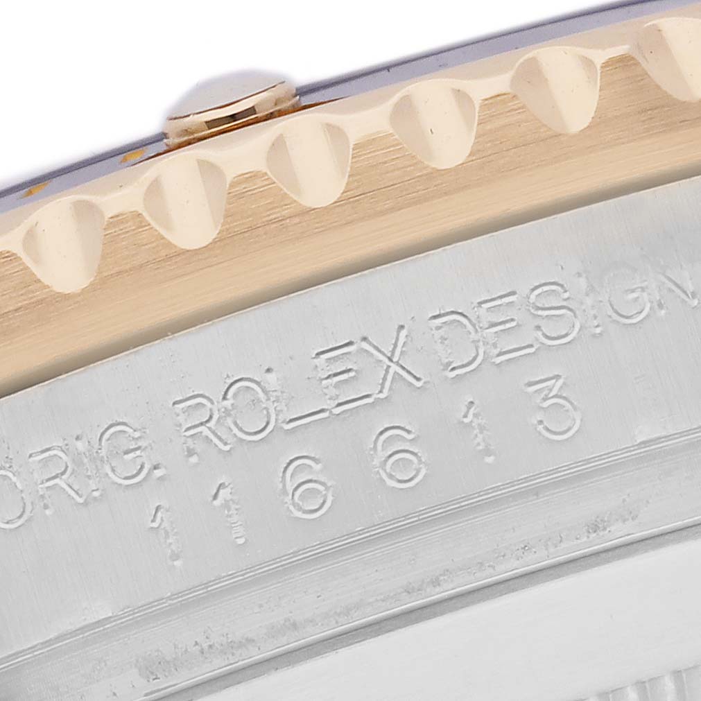 The image shows a close-up of the case side and bezel of the Rolex Submariner 116613 Men's Steel and Gold (two tone) Black Dial 116613 Men's Steel and Gold (two tone) Black Dial, highlighting the engraving.
