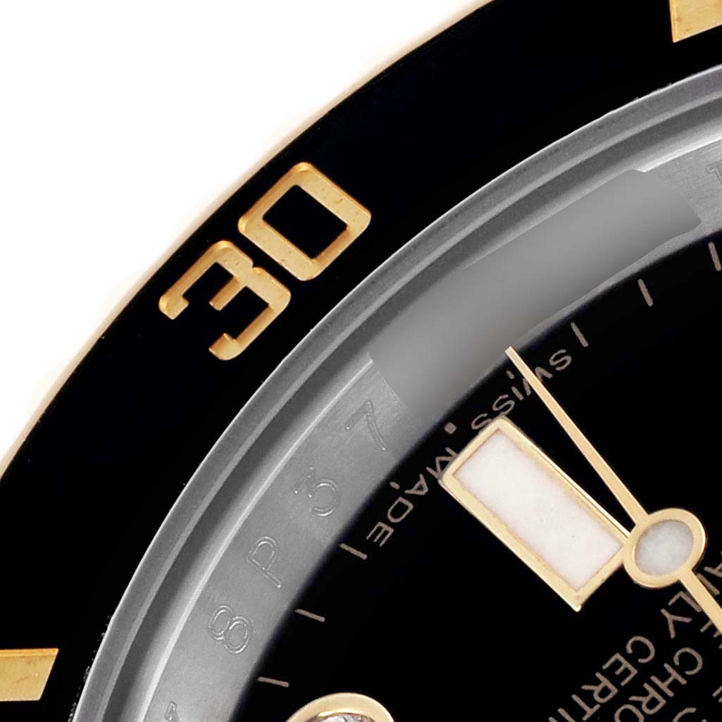 This image shows a close-up of the Rolex Submariner 116613 Men's Steel and Gold (two tone) Black Dial 116613 Men's Steel and Gold (two tone) Black Dial's bezel and part of the dial, highlighting the "30" marker and watch hands.