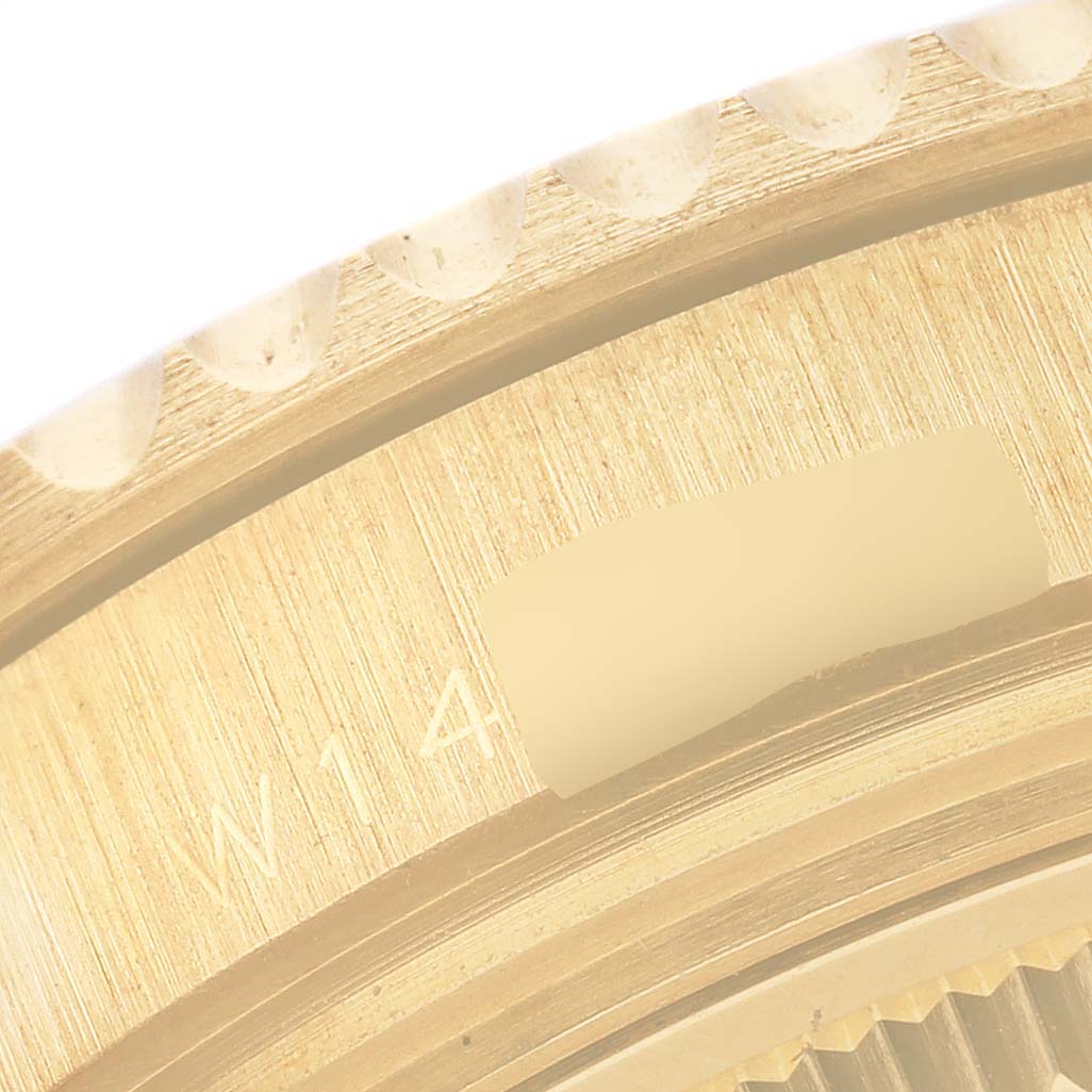 The image shows a close-up of the bezel edge and part of the case of a Rolex Yacht-Master 68628 Men's Yellow Gold Blue Dial 68628 Men's Yellow Gold Blue Dial watch.