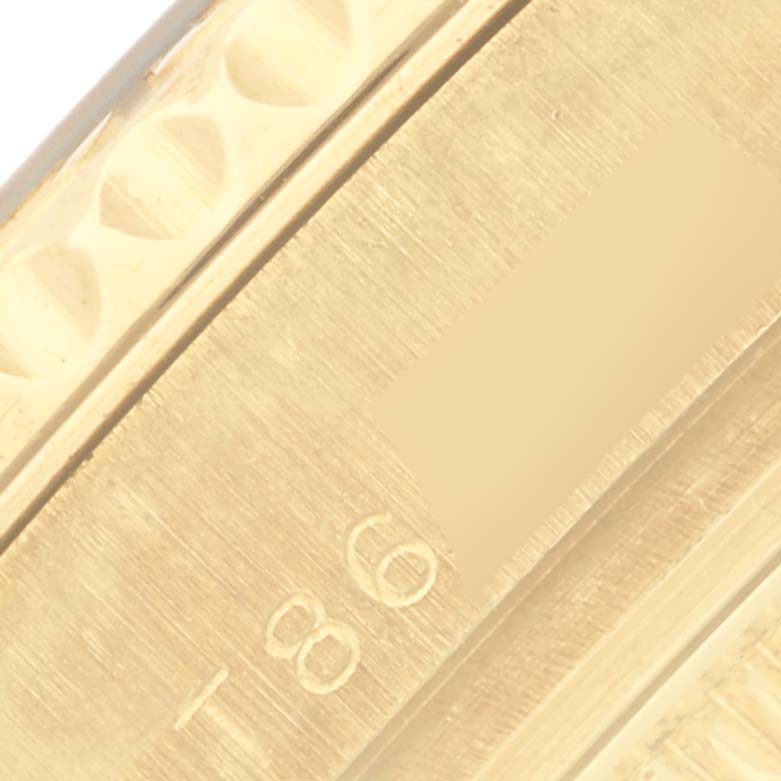 The image shows a close-up angle of the engraved inner bezel of a Rolex Mid-Size model.