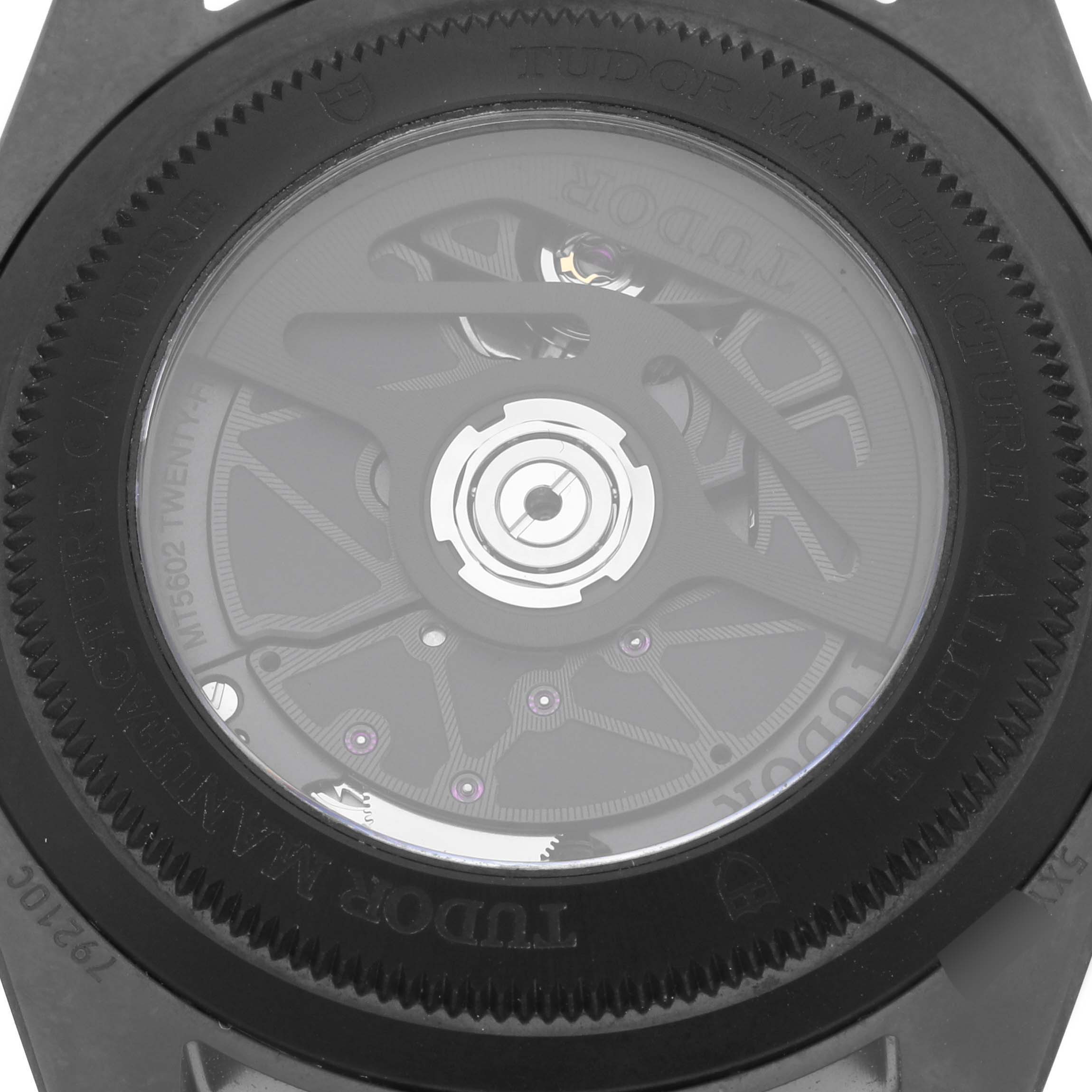 The image shows the back of a Tudor Heritage Black Bay 79210CNU Men's Stainless Steel Black Dial 79210CNU Men's Stainless Steel Black Dial, highlighting the movement and details of the transparent case back.