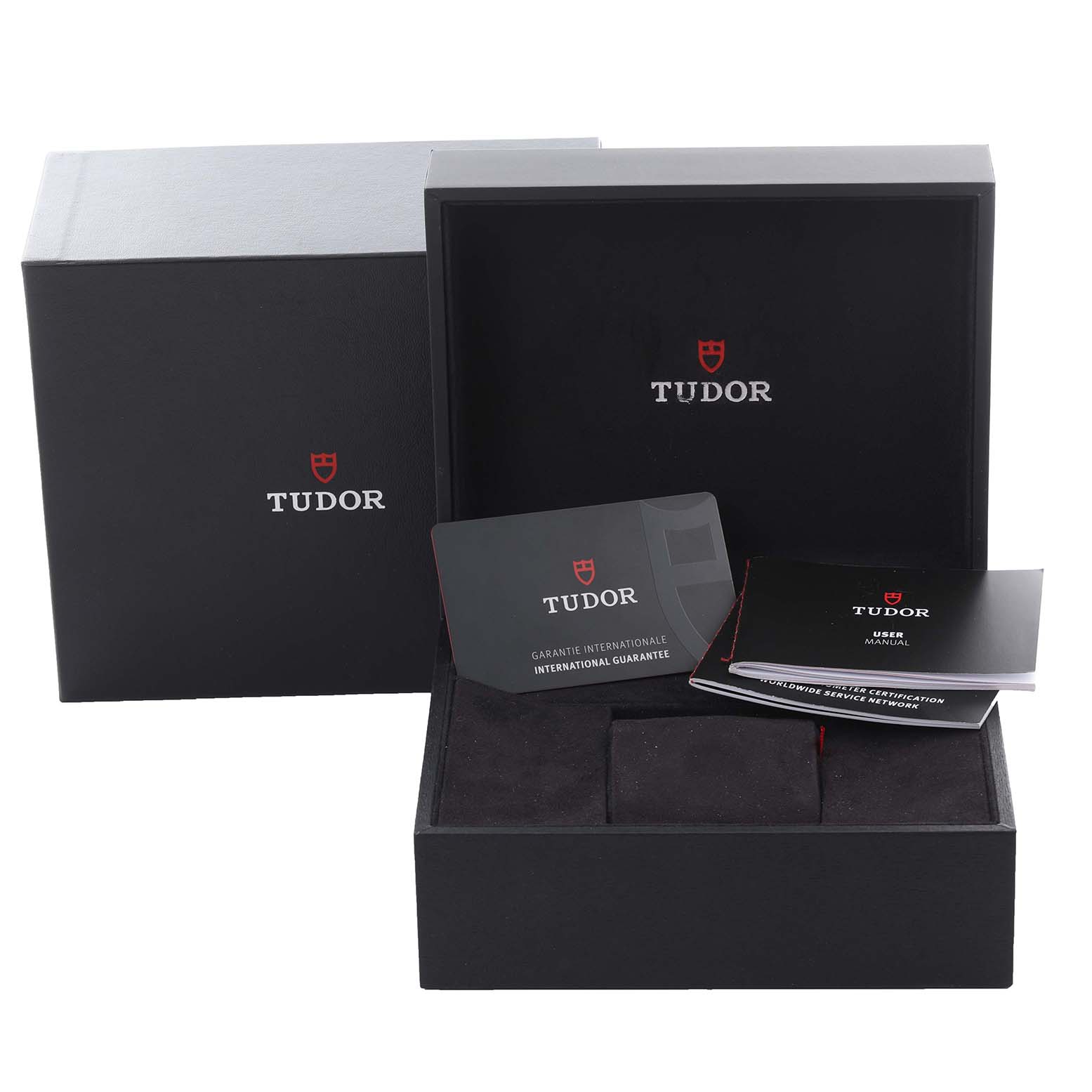 The image shows the packaging and accessories for a Tudor Heritage Black Bay 79830RB-0003 Men's Stainless Steel Black Dial 79830RB-0003 Men's Stainless Steel Black Dial watch, including a box, manual, and guarantee card.