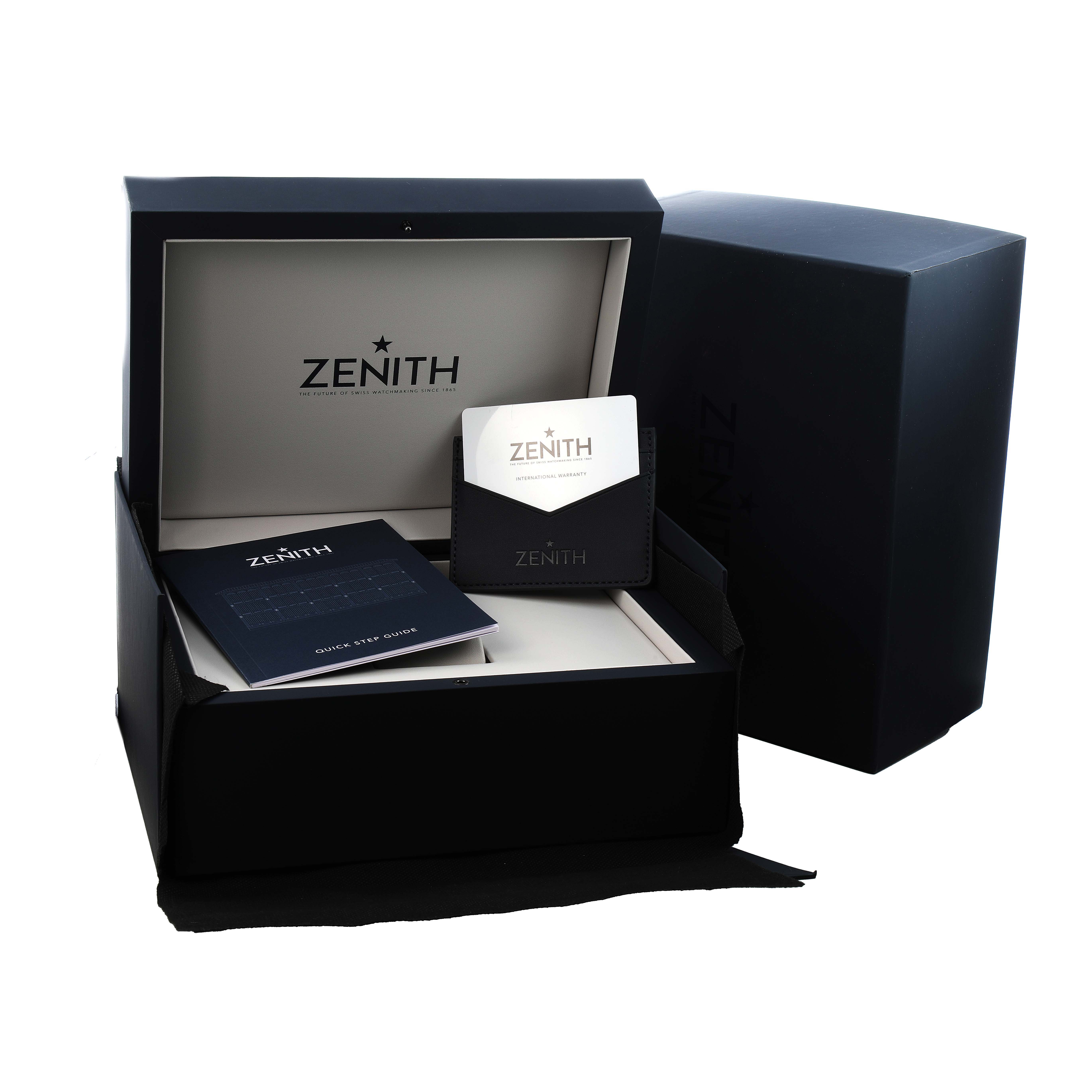 The image shows an open box of a Zenith Chronomaster 03.3108.3600/57.M3100 Men's Stainless Steel Green Dial with a booklet and warranty card from a top-front angle.