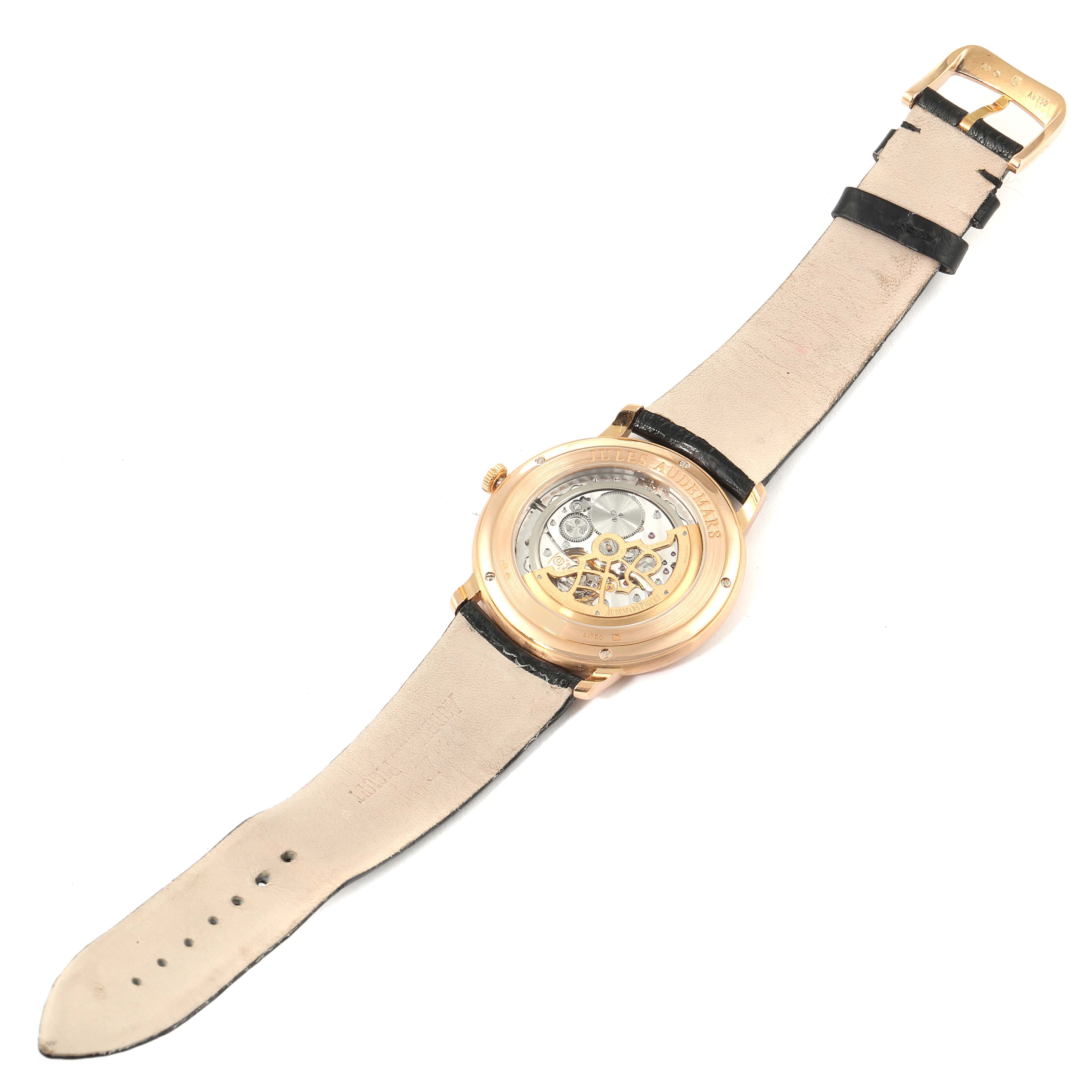 The image shows the back view of the Audemars Piguet Jules 15180OR.OO.A102CR.01 Men's Rose Gold Silver Dial 15180OR.OO.A102CR.01 Men's Rose Gold Silver Dial model watch, revealing the internal mechanisms and strap.