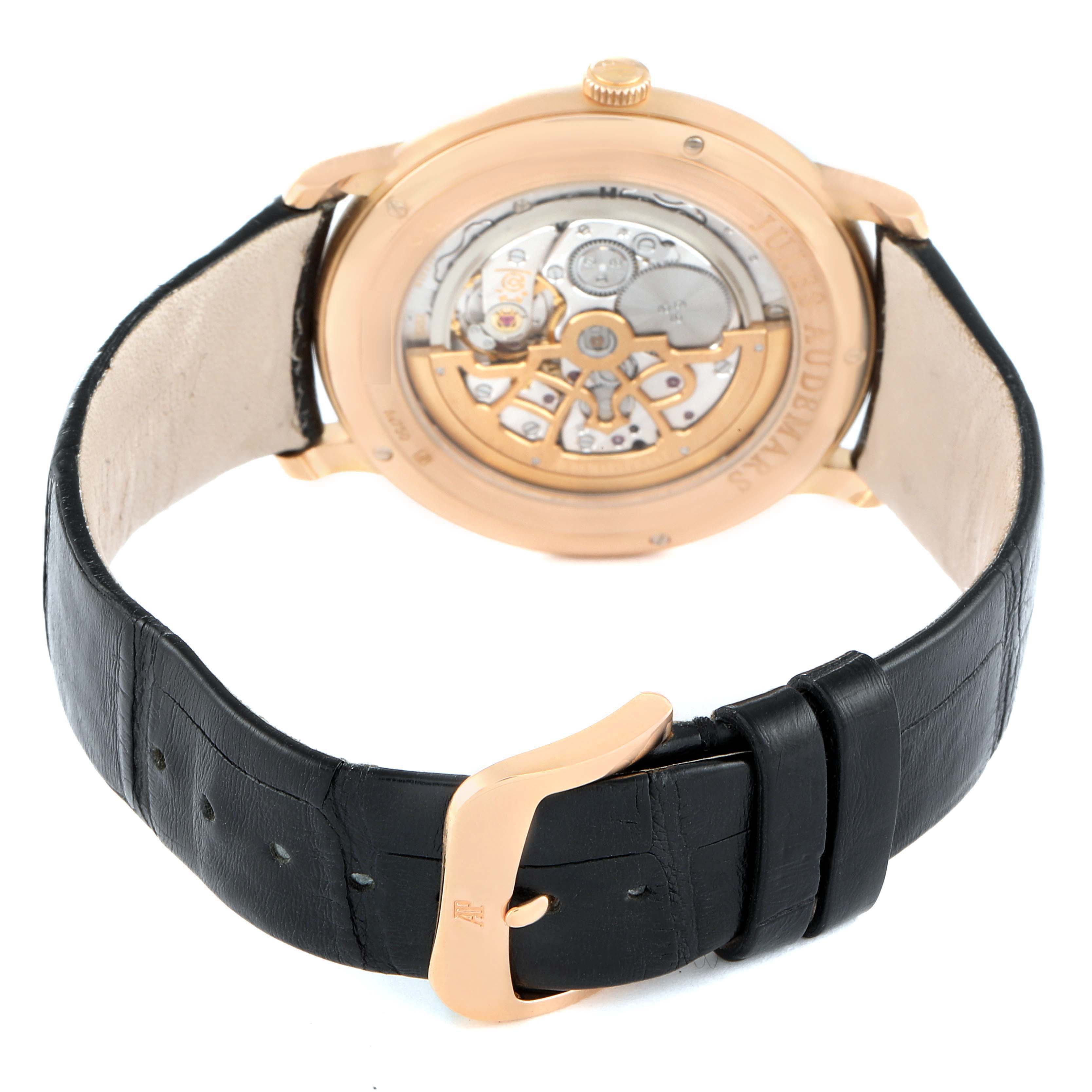 The image shows the back of the Audemars Piguet Jules 15180OR.OO.A102CR.01 Men's Rose Gold Silver Dial watch, highlighting the mechanical movement and leather strap.