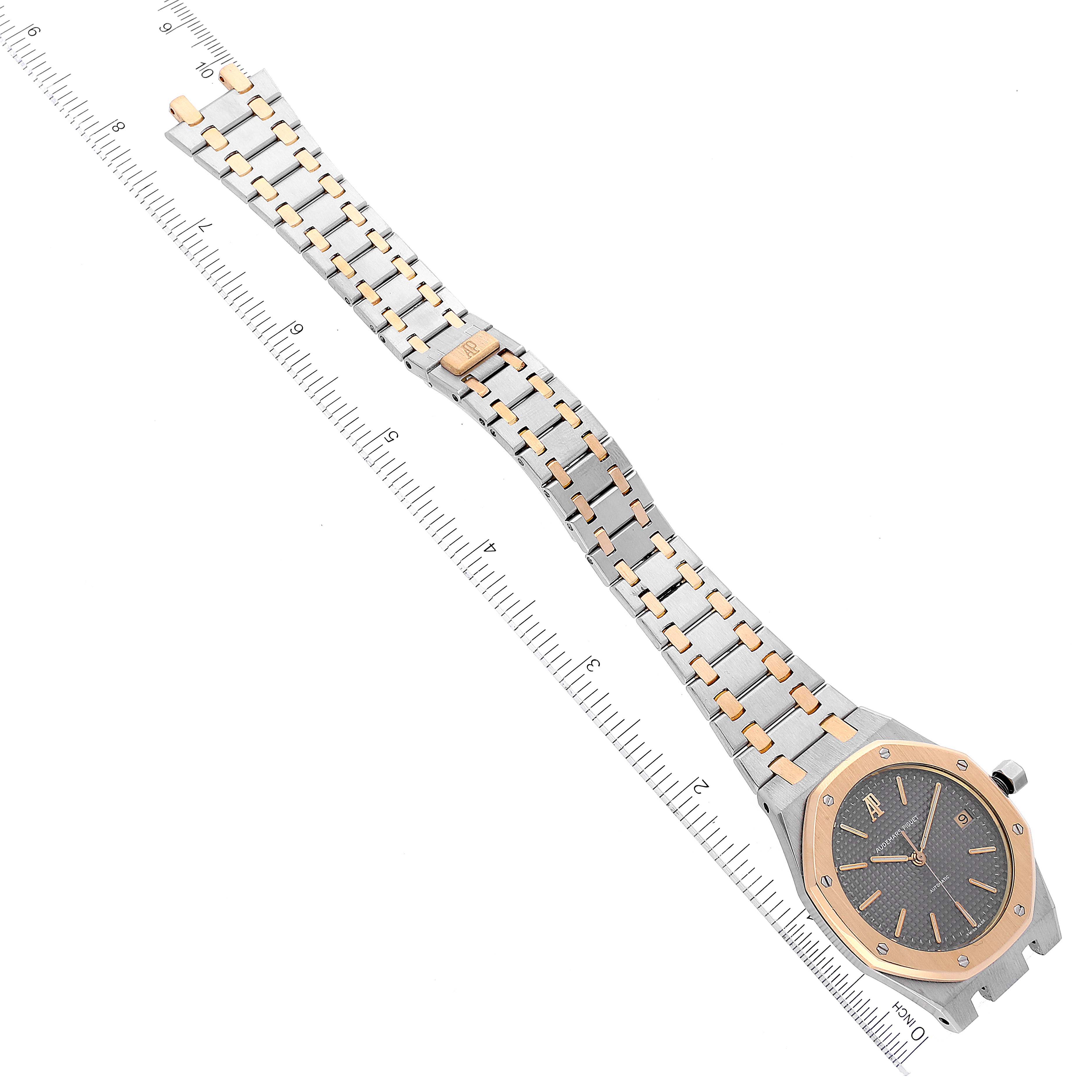 This image shows an Audemars Piguet Royal Oak 14790SA.OO.0789SA.01 Men's Steel and Gold (two tone) Grey Dial 14790SA.OO.0789SA.01 Men's Steel and Gold (two tone) Grey Dial watch, featuring a two-tone metal bracelet and bezel, viewed from a top-down angle.