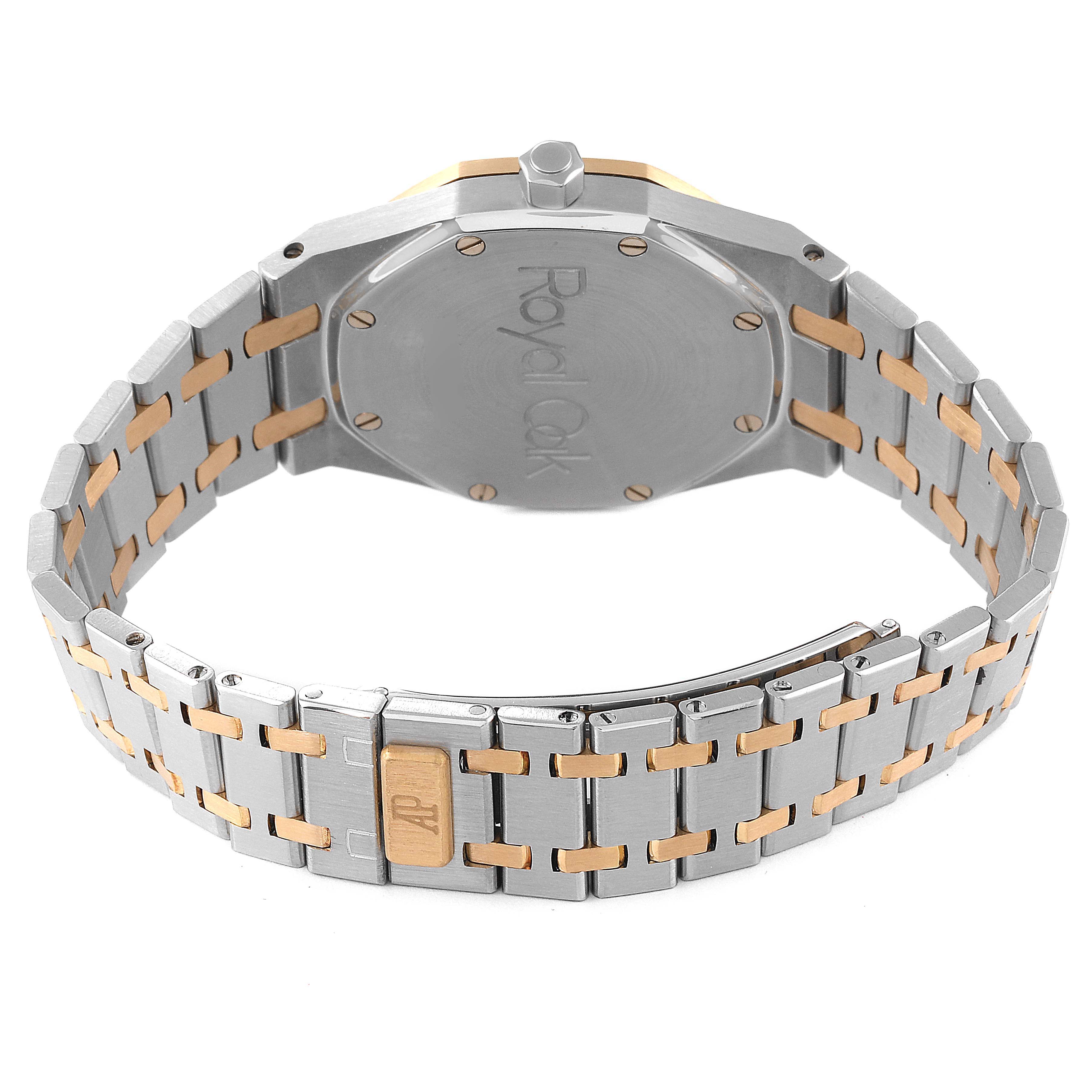 The image shows the back view of an Audemars Piguet Royal Oak 14790SA.OO.0789SA.01 Men's Steel and Gold (two tone) Grey Dial 14790SA.OO.0789SA.01 Men's Steel and Gold (two tone) Grey Dial watch, prominently displaying the case back and the two-tone metal bracelet.