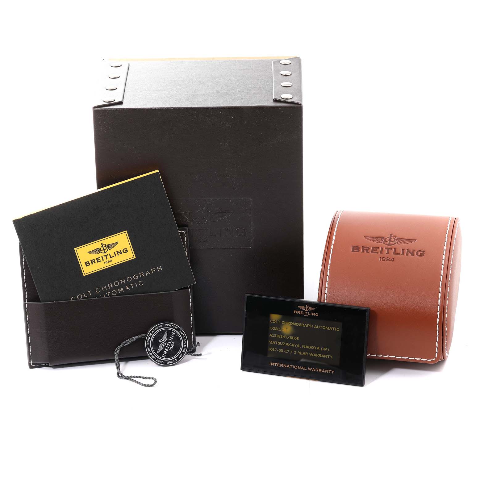 The image shows the packaging, manual, warranty card, and case for the Breitling Limited Series Colt Chronograph Automatic watch.