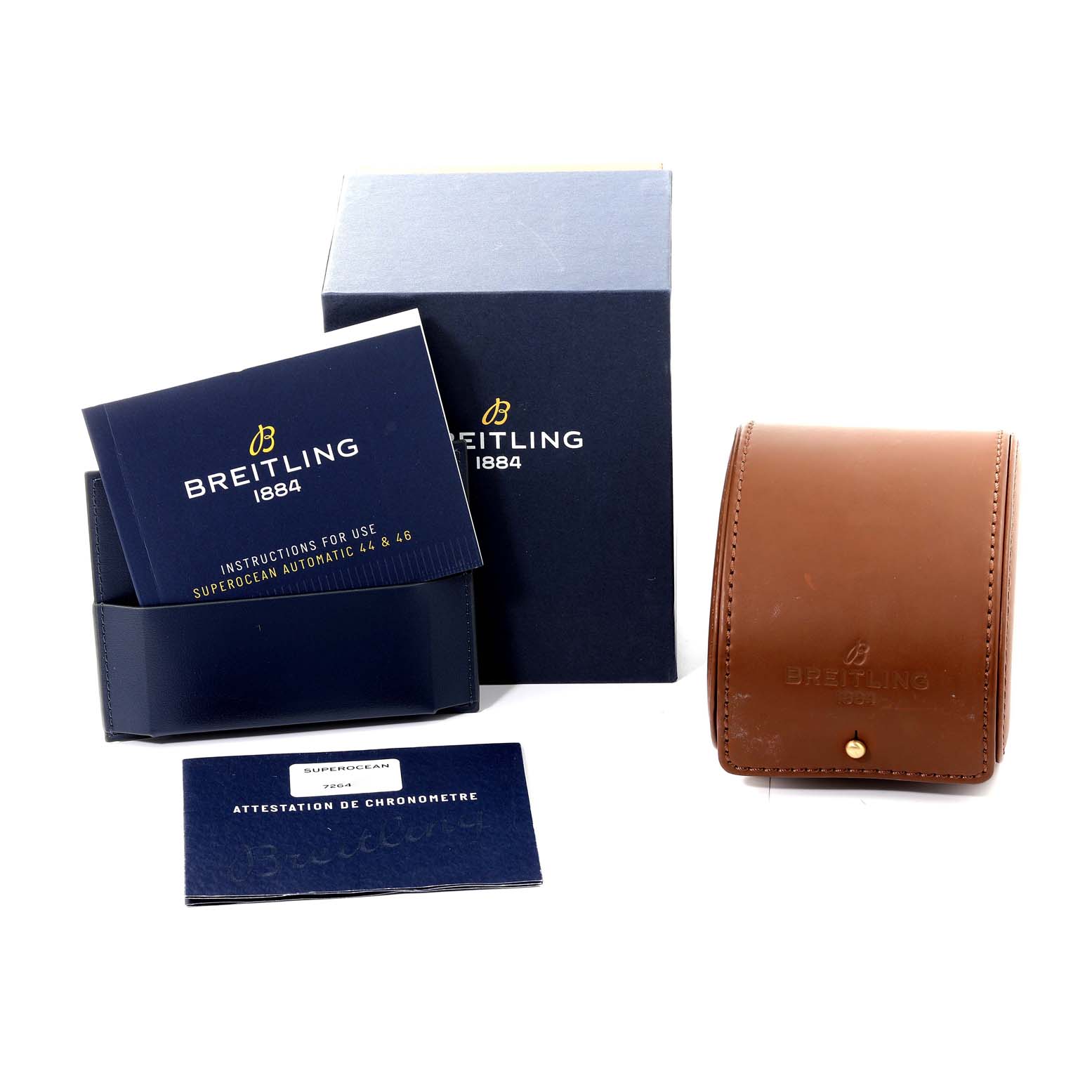 The image shows the accessories for the Breitling Superocean M17368 Men's Stainless Steel Black Dial M17368 Men's Stainless Steel Black Dial model, including the box, manuals, certificate, and a leather travel case.