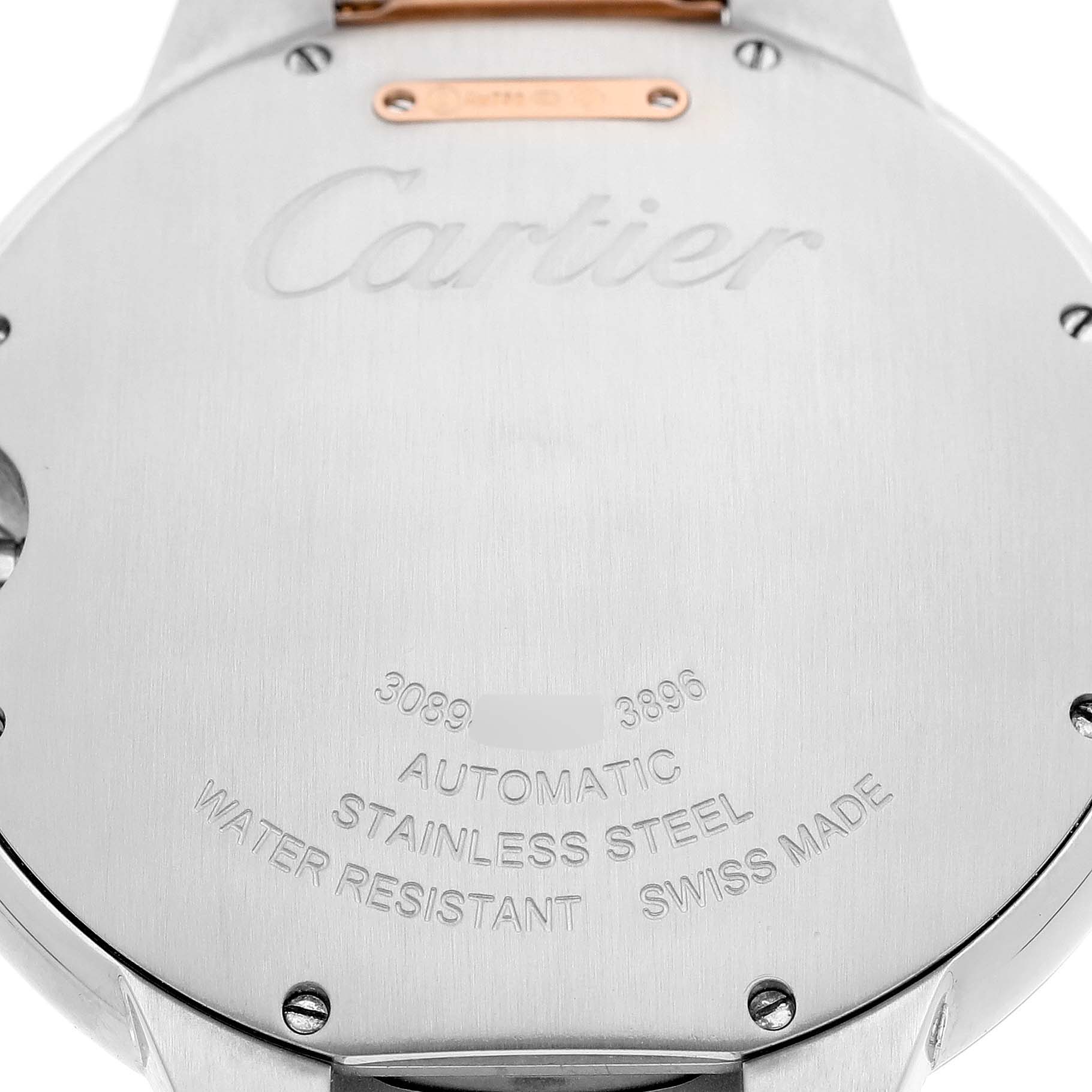 The image shows the back of a Cartier Ballon Bleu W2BB0004 Men's Steel and Gold (two tone) Silver Dial watch, highlighting its engravings and stainless steel casing.