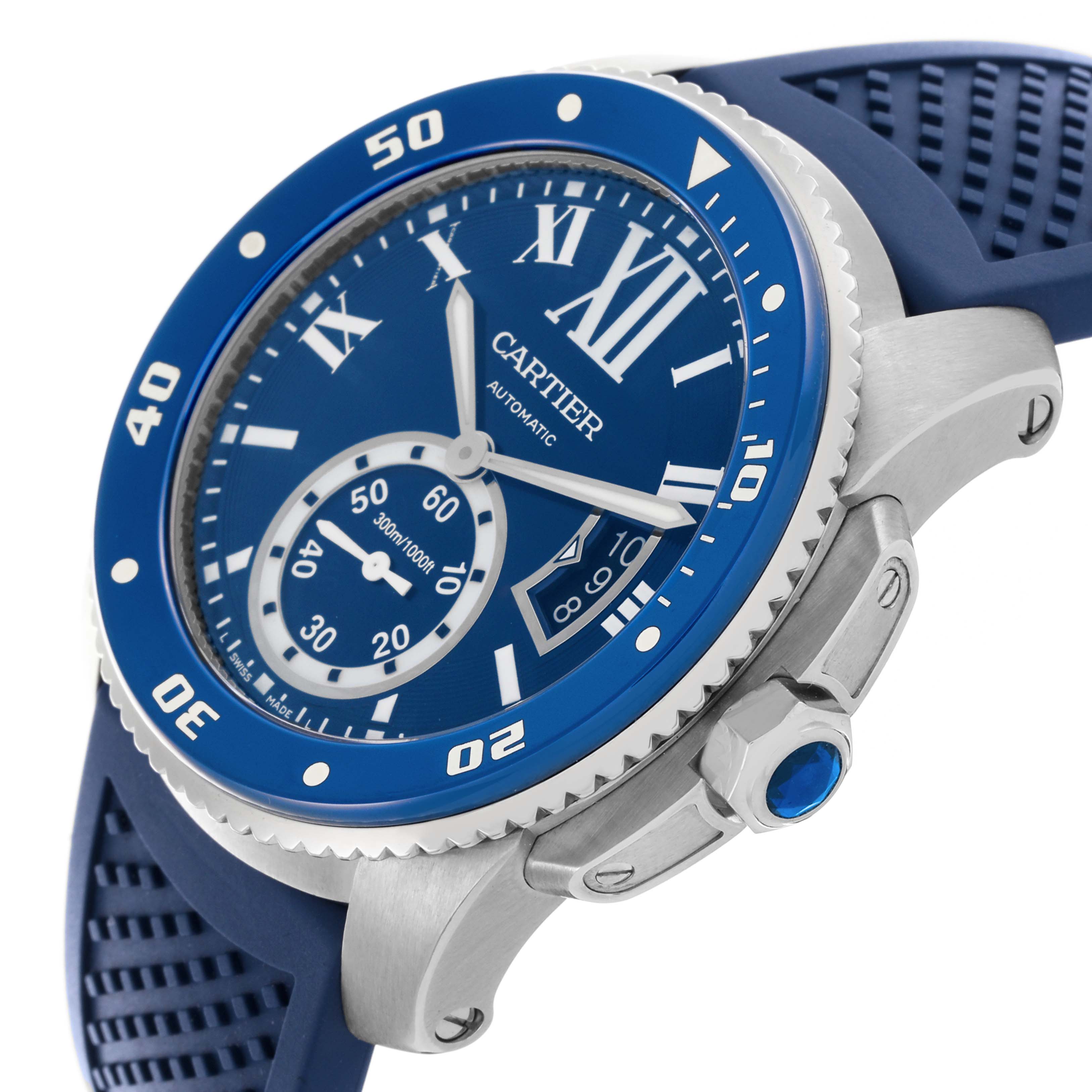 The image shows a Drive de Cartier watch from an angled side view, highlighting the blue dial, bezel, crown, and silicone strap.