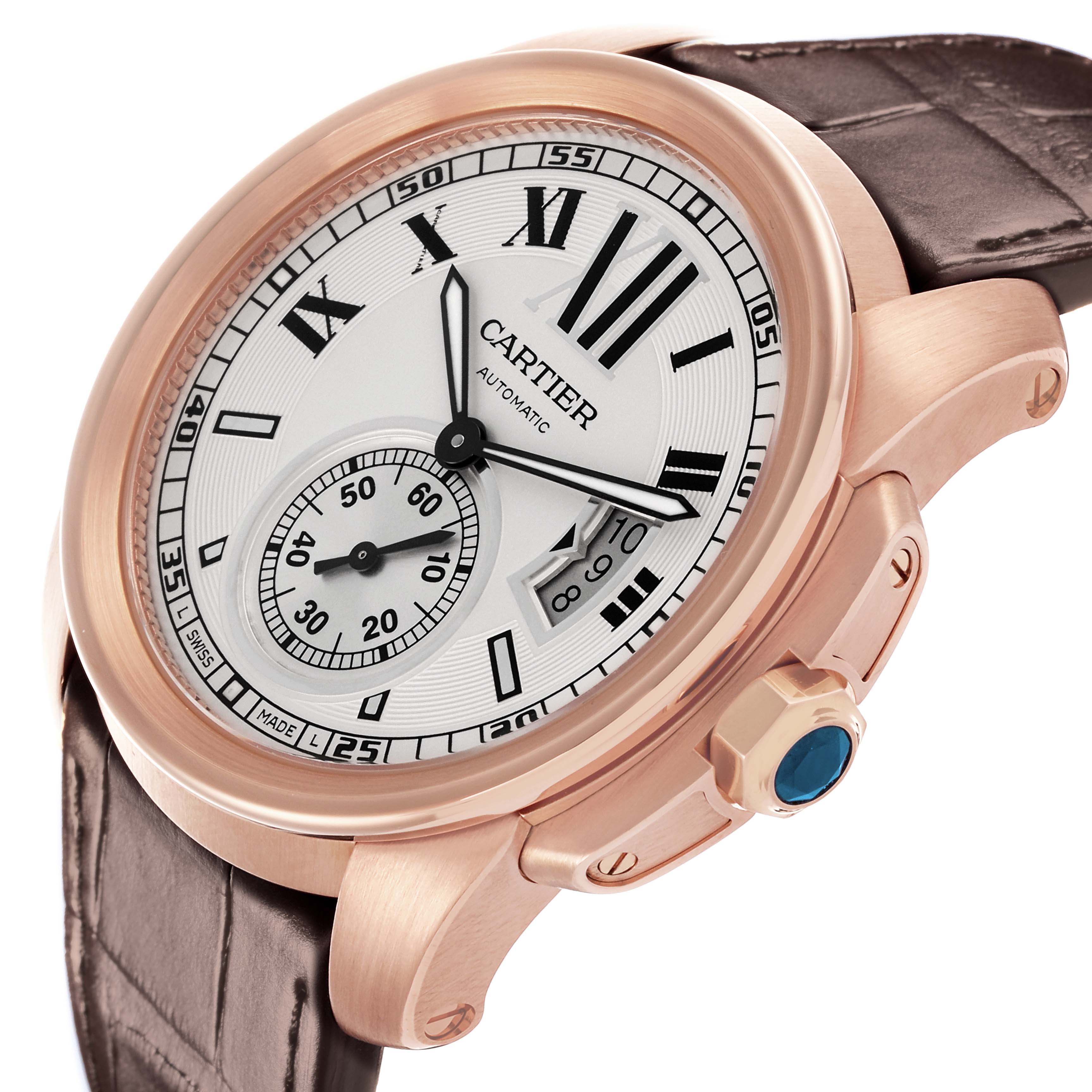 The Calibre de Cartier watch is shown at a slight angle, highlighting the dial, crown, bezel, and leather strap.