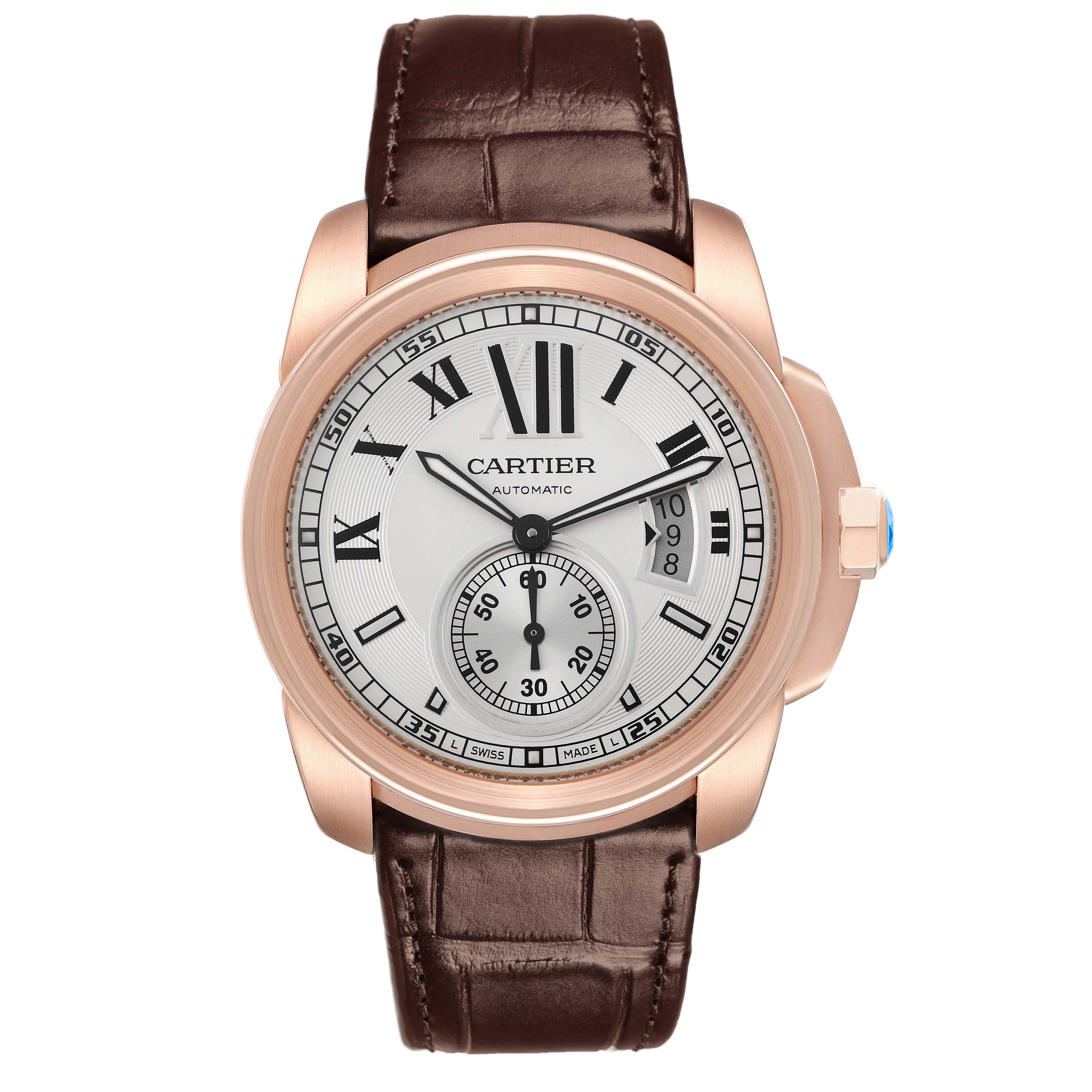 The image shows a front view of the Calibre de Cartier watch, highlighting the dial, hands, and leather strap.