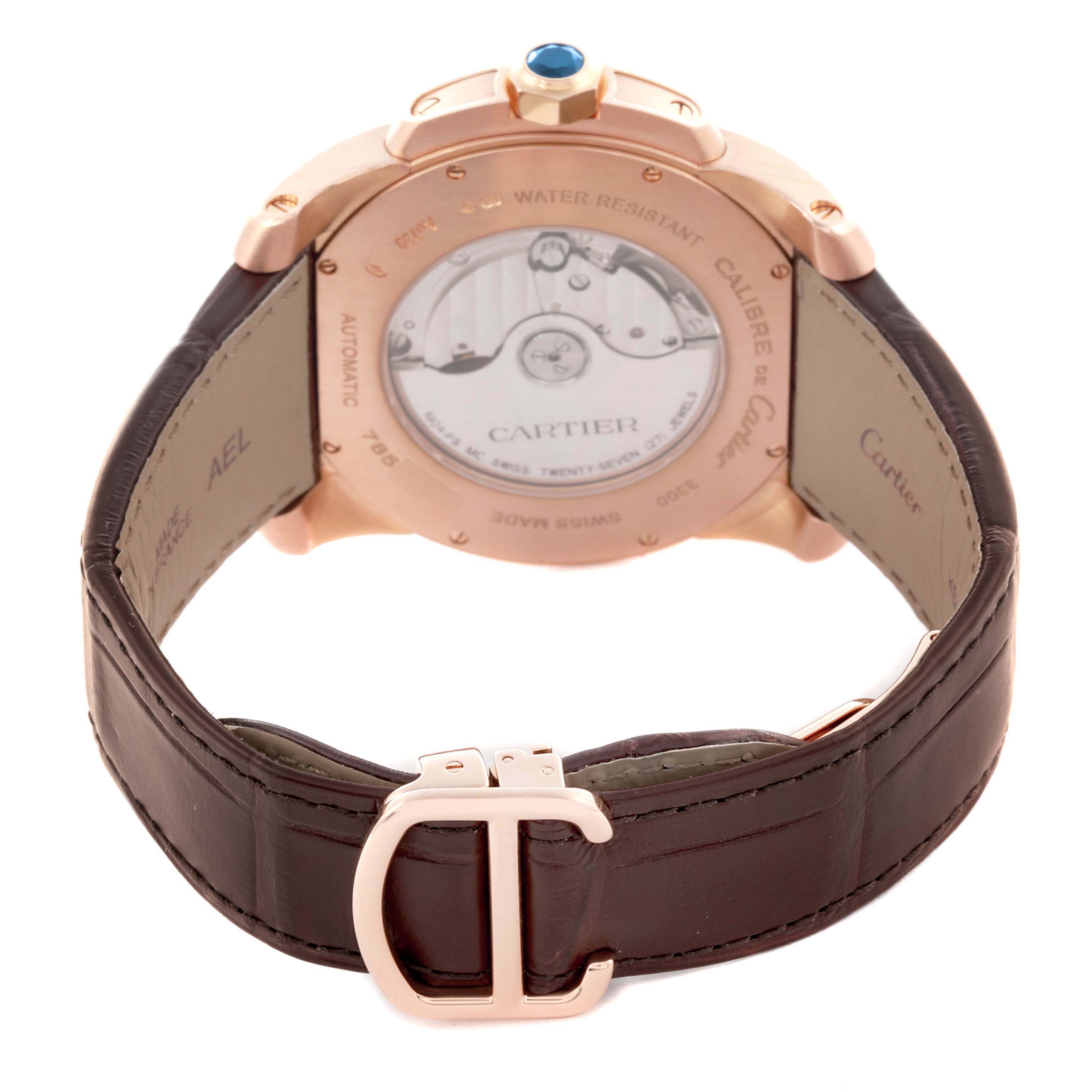 The image shows the back view of a Calibre de Cartier watch, highlighting the case back, movement, and leather strap.