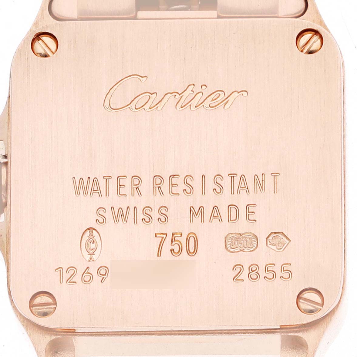 The image shows the back case of the Cartier Santos Demoiselle W25077X9 Women
s Rose Gold Silver Dial W25077X9 Women
s Rose Gold Silver Dial watch, highlighting engravings and screws.