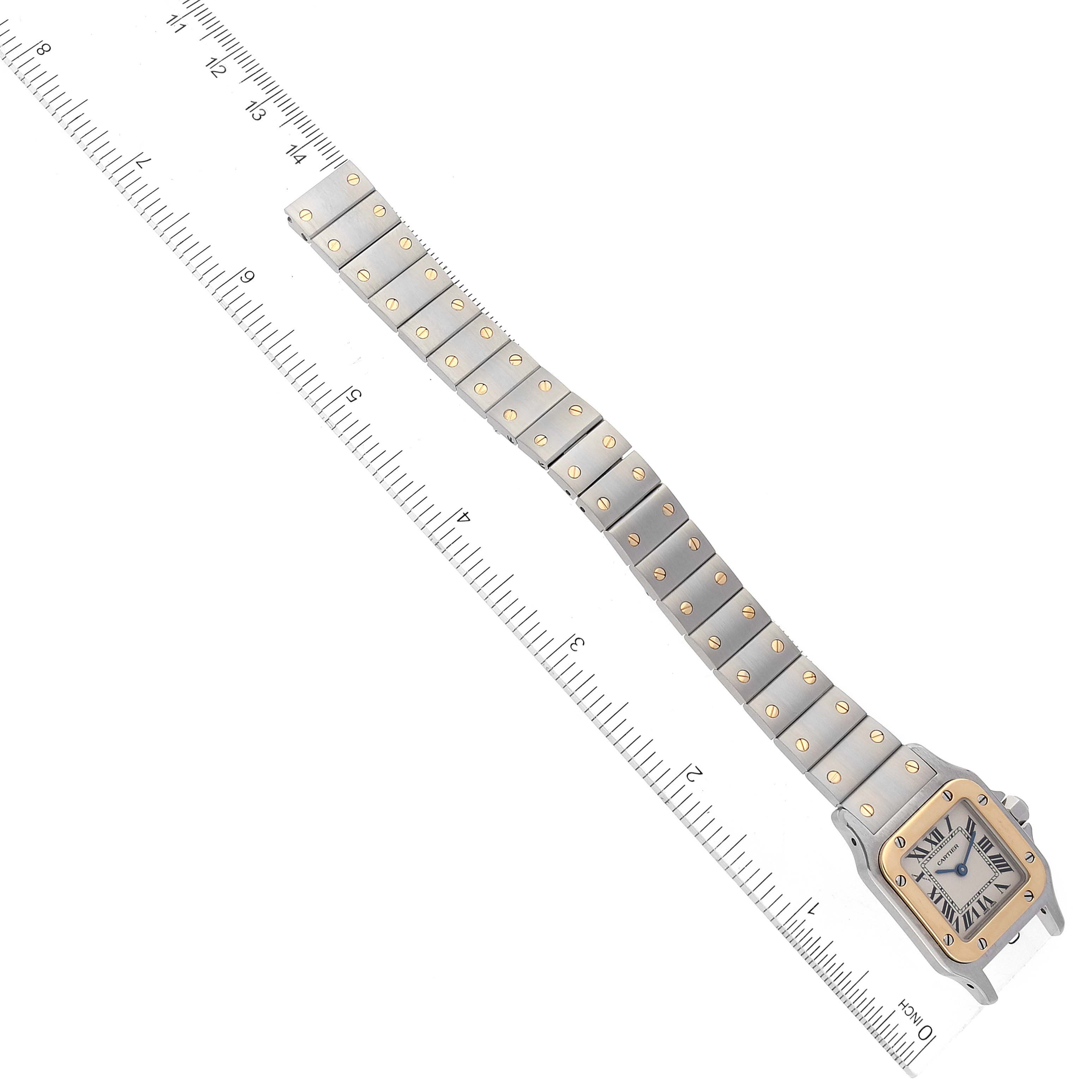 The image shows a top view of a Cartier Santos W20012C4 Women's Steel and Gold (two tone) Silver Dial W20012C4 Women's Steel and Gold (two tone) Silver Dial watch, displaying both the face and full length of the metal bracelet.