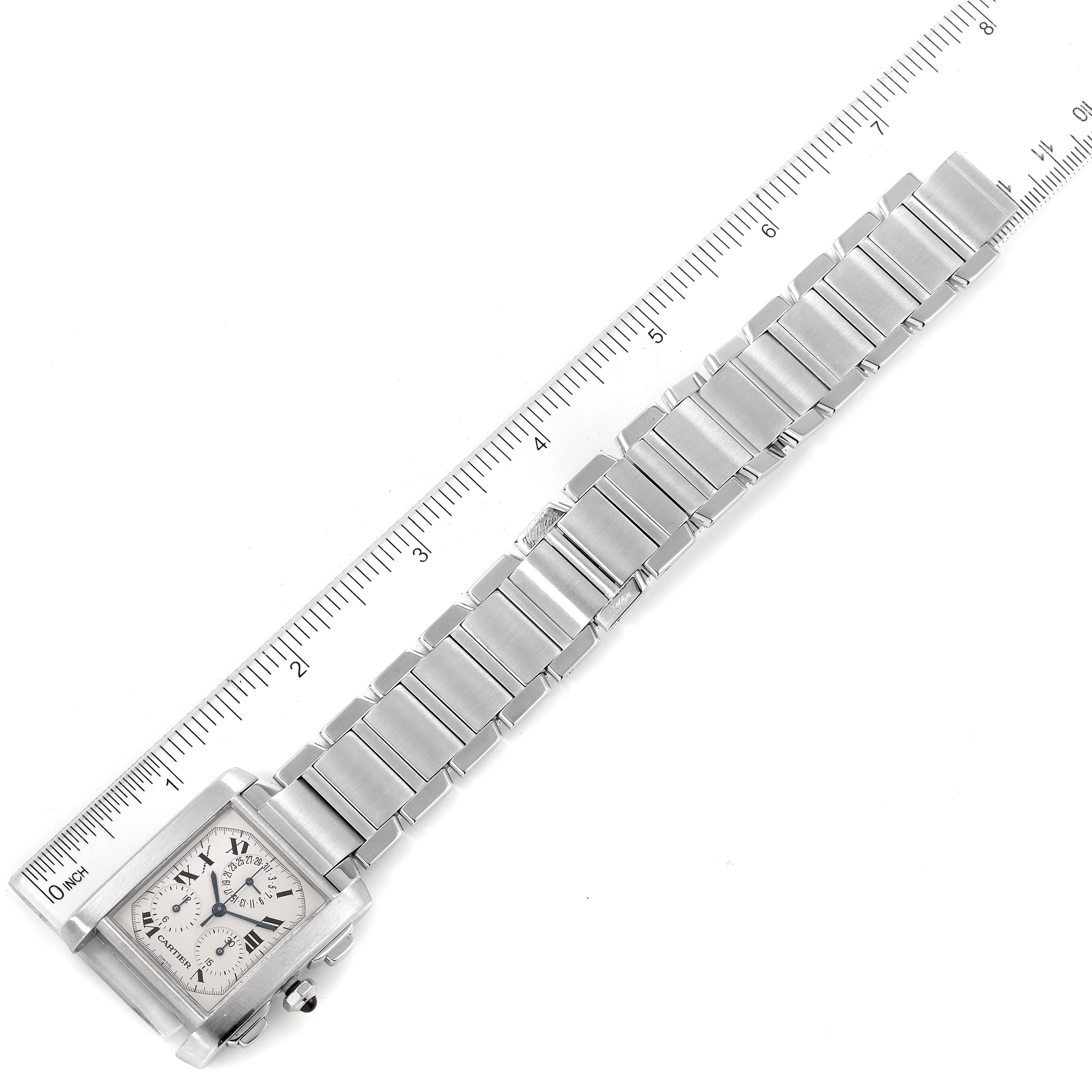 This image shows a top view of a Cartier Tank Francaise W51001Q3 Men's Stainless Steel Silver Dial W51001Q3 Men's Stainless Steel Silver Dial watch, displaying its full bracelet and part of the face next to a ruler.
