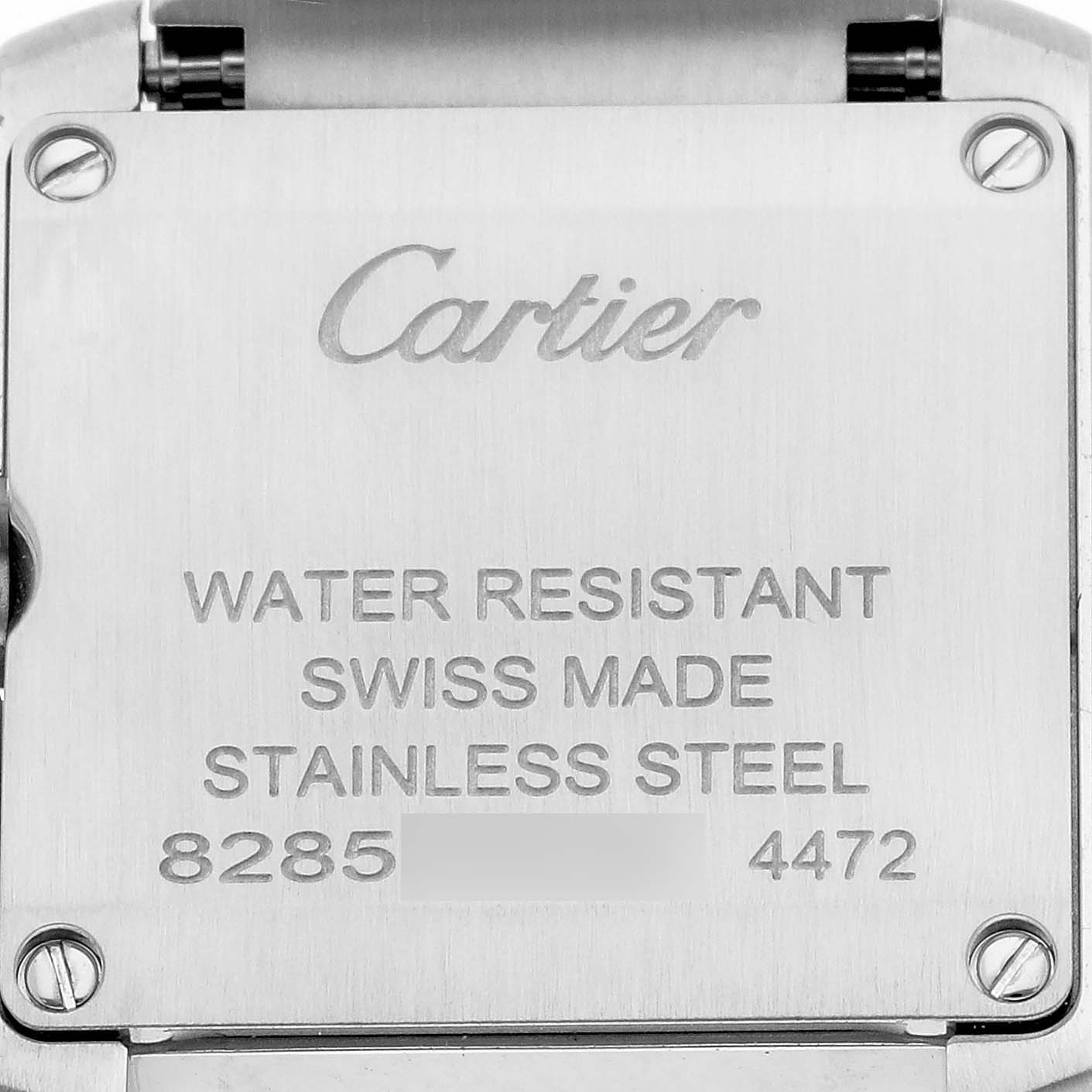 The image shows the back of a Cartier Tank Française watch engraved with details like "WATER RESISTANT" and "SWISS MADE".