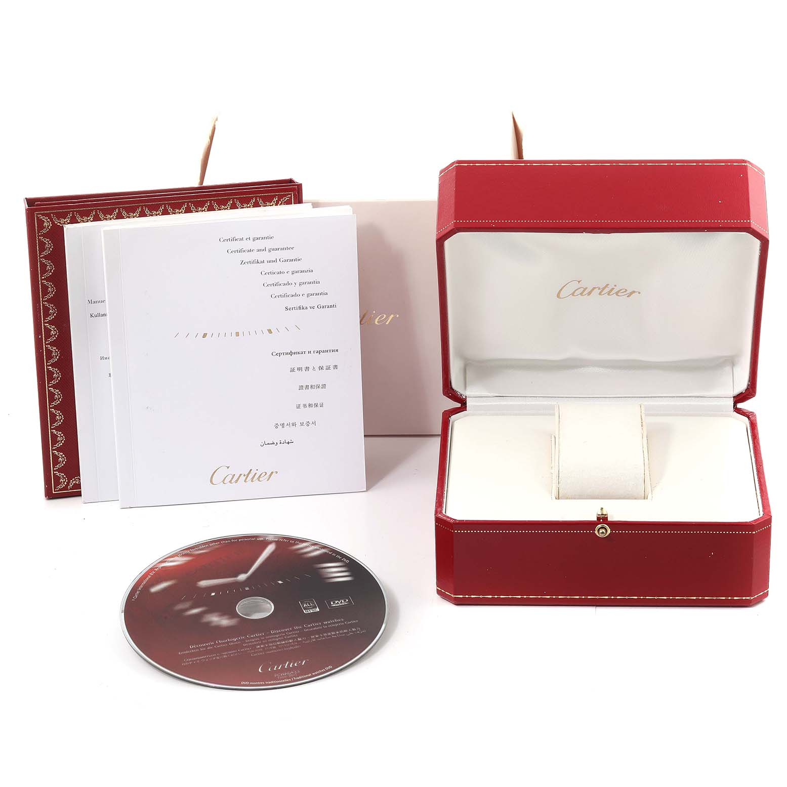 This image shows a Cartier Tank Louis W1529856 Women's Yellow Gold Silver Dial W1529856 Women's Yellow Gold Silver Dial watch box at an angle, accompanying guarantee booklets, and a CD.