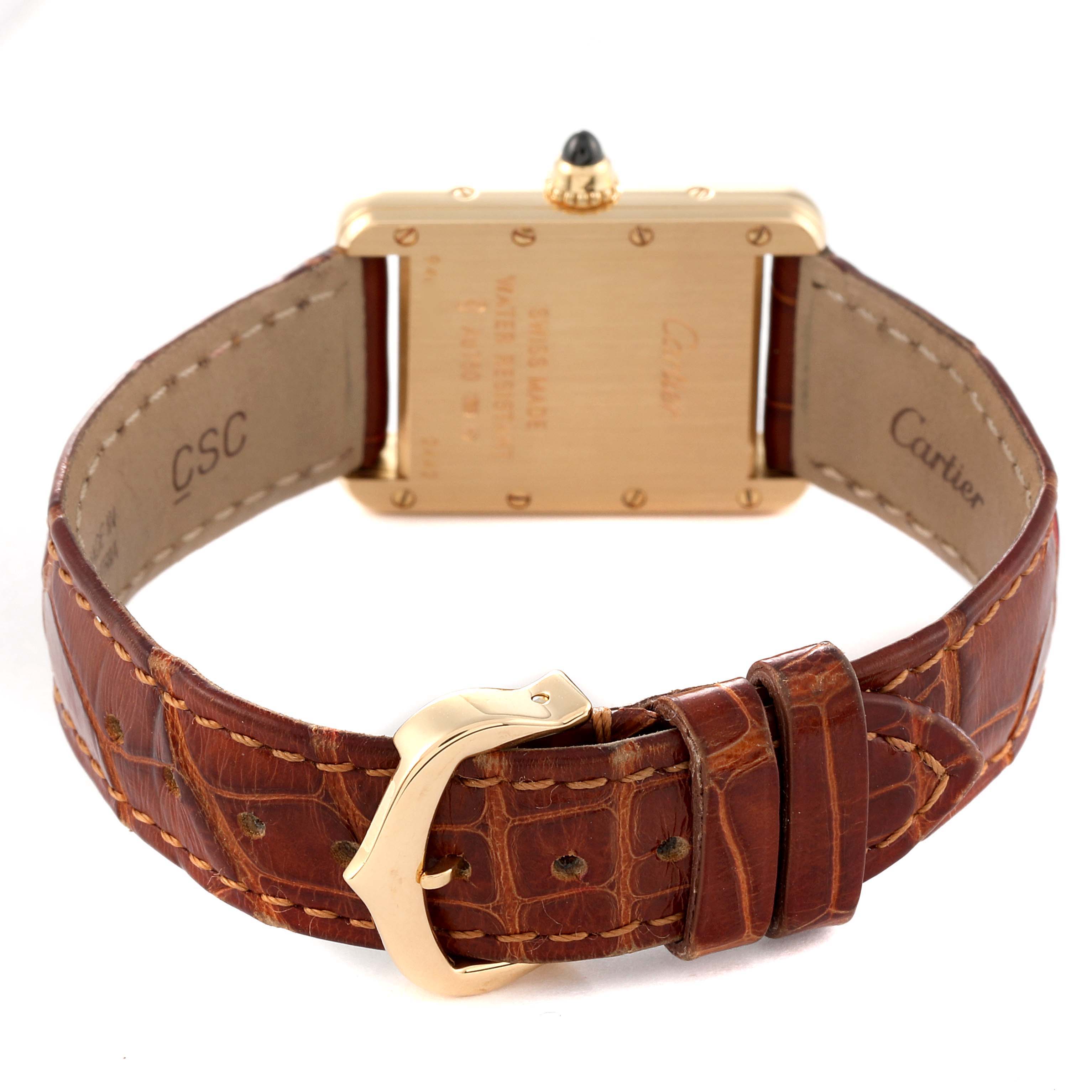 The image shows the back and strap of a Cartier Tank Louis W1529856 Women's Yellow Gold Silver Dial W1529856 Women's Yellow Gold Silver Dial watch, highlighting the gold case and brown leather strap with a buckle.
