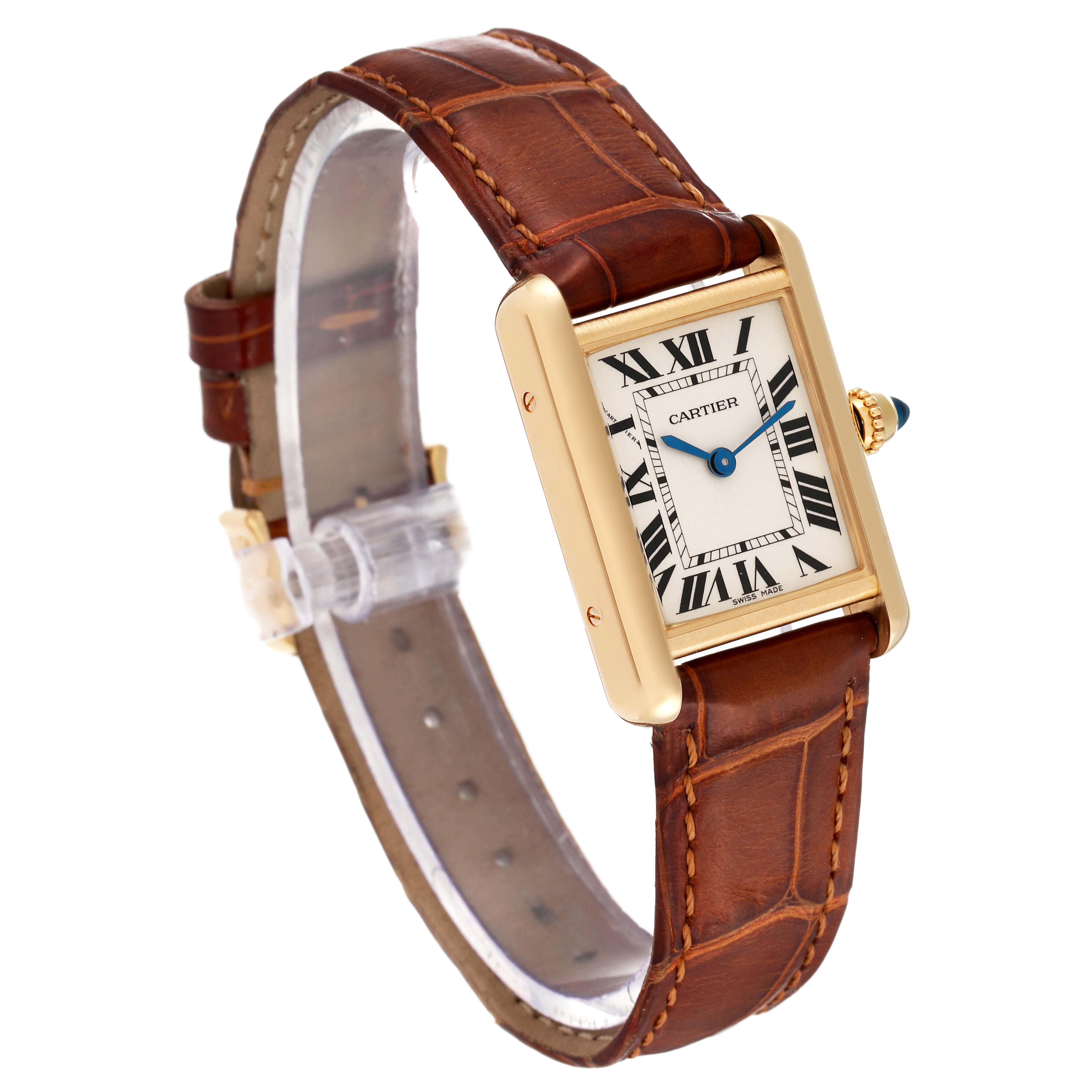 This Tank Louis Cartier watch is shown from a top-side angle, highlighting its rectangular dial, brown leather strap, and gold casing.
