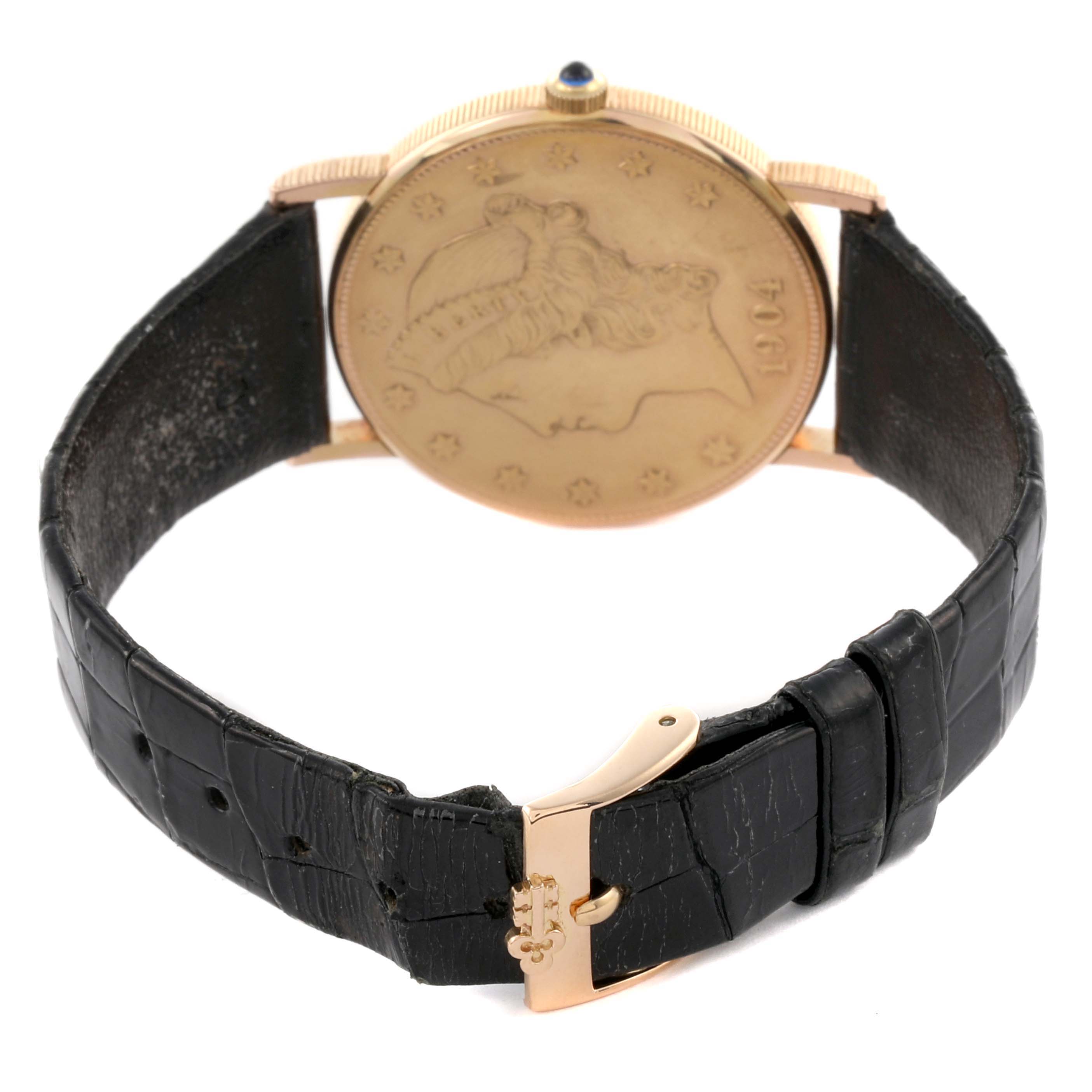 The image shows the back of a Corum Coin Watch 4414556 Men's Yellow Gold Champagne Dial 4414556 Men's Yellow Gold Champagne Dial model, highlighting the coin design on the case and the black leather strap with a buckle.