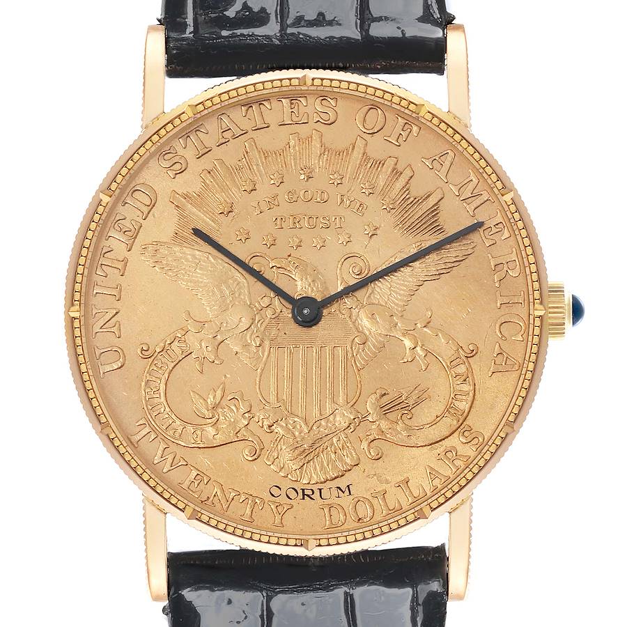 The Corum Coin Watch model is shown from the front, displaying the engraved coin dial, hands, crown, and leather strap attachment.