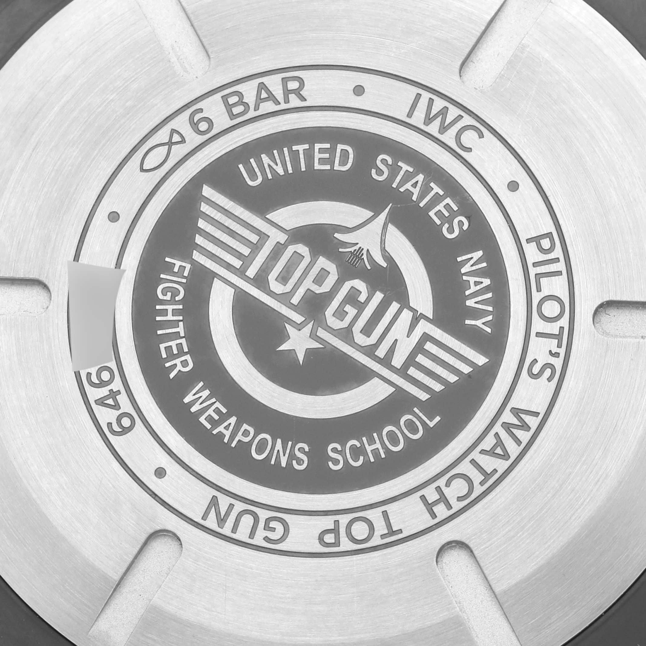 The image shows the back of an IWC Pilot IW389101 Men's Ceramic Black Dial IW389101 Men's Ceramic Black Dial's Watch, featuring the "Top Gun" engraving.