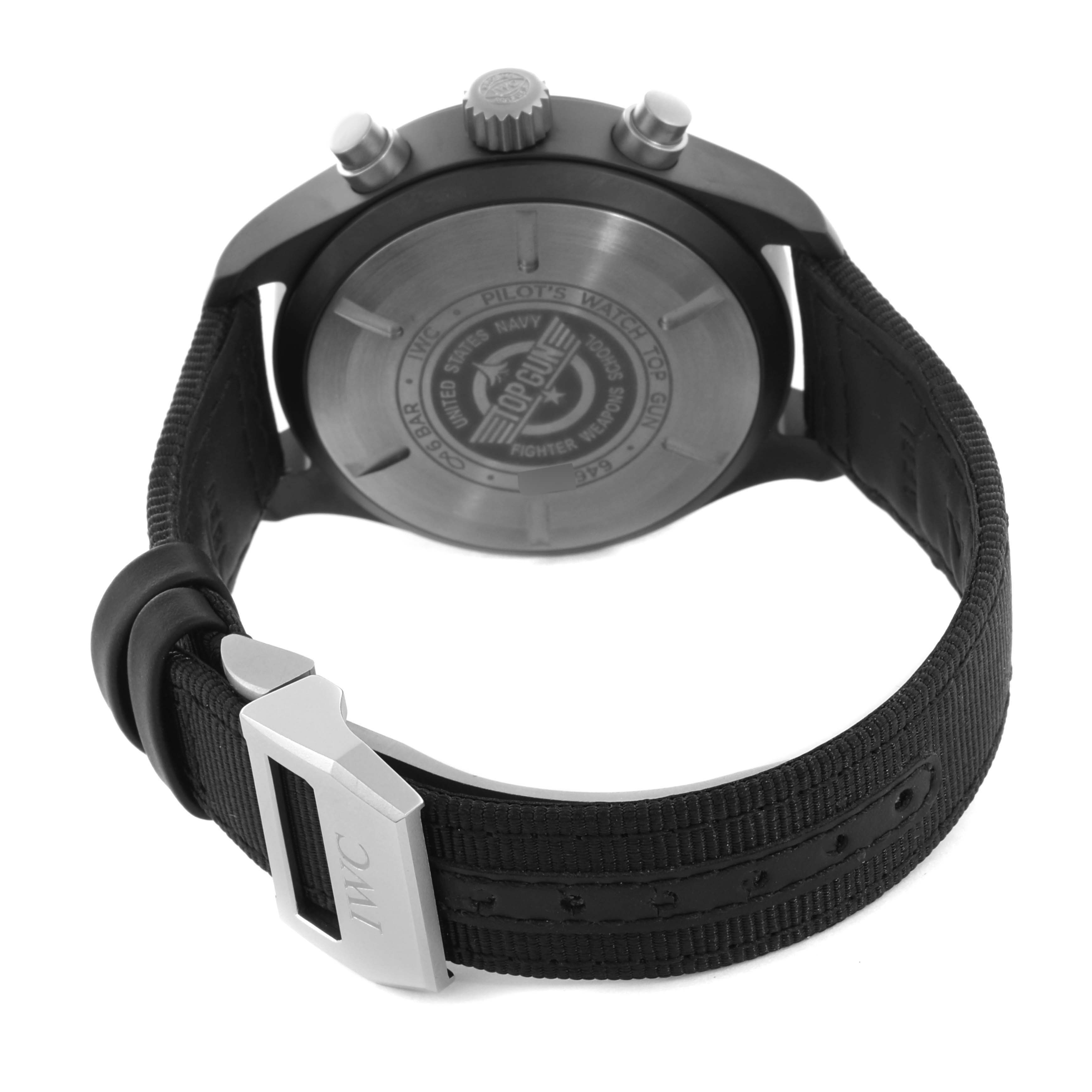 The IWC Pilot IW389101 Men's Ceramic Black Dial IW389101 Men's Ceramic Black Dial watch is shown from the back, featuring the case back, pushers, crown, and a partially open strap with buckle.