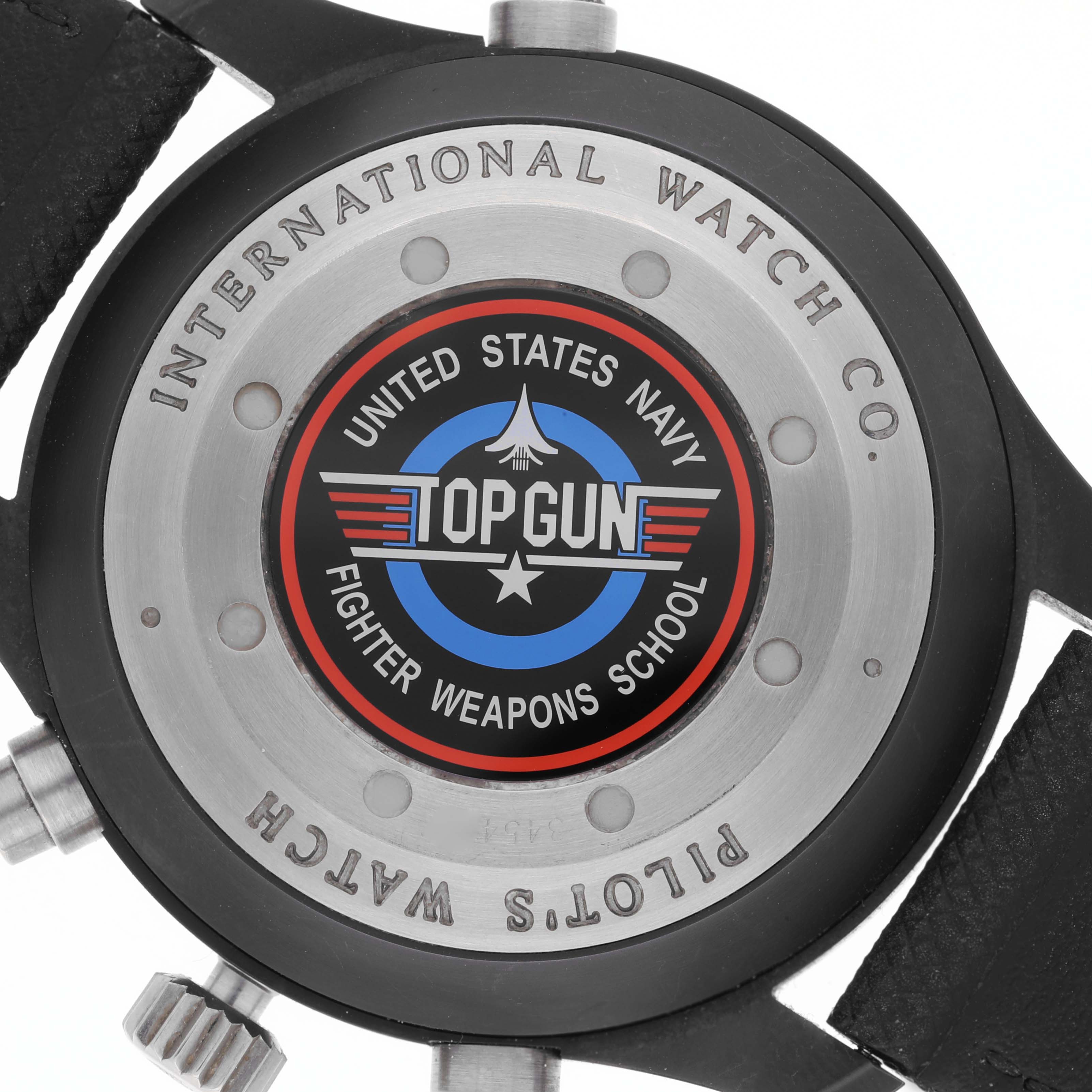 The image shows the back of the IWC Pilot IW379901 Men's Ceramic Black Dial IW379901 Men's Ceramic Black Dial model watch with a "Top Gun" emblem and branding details.