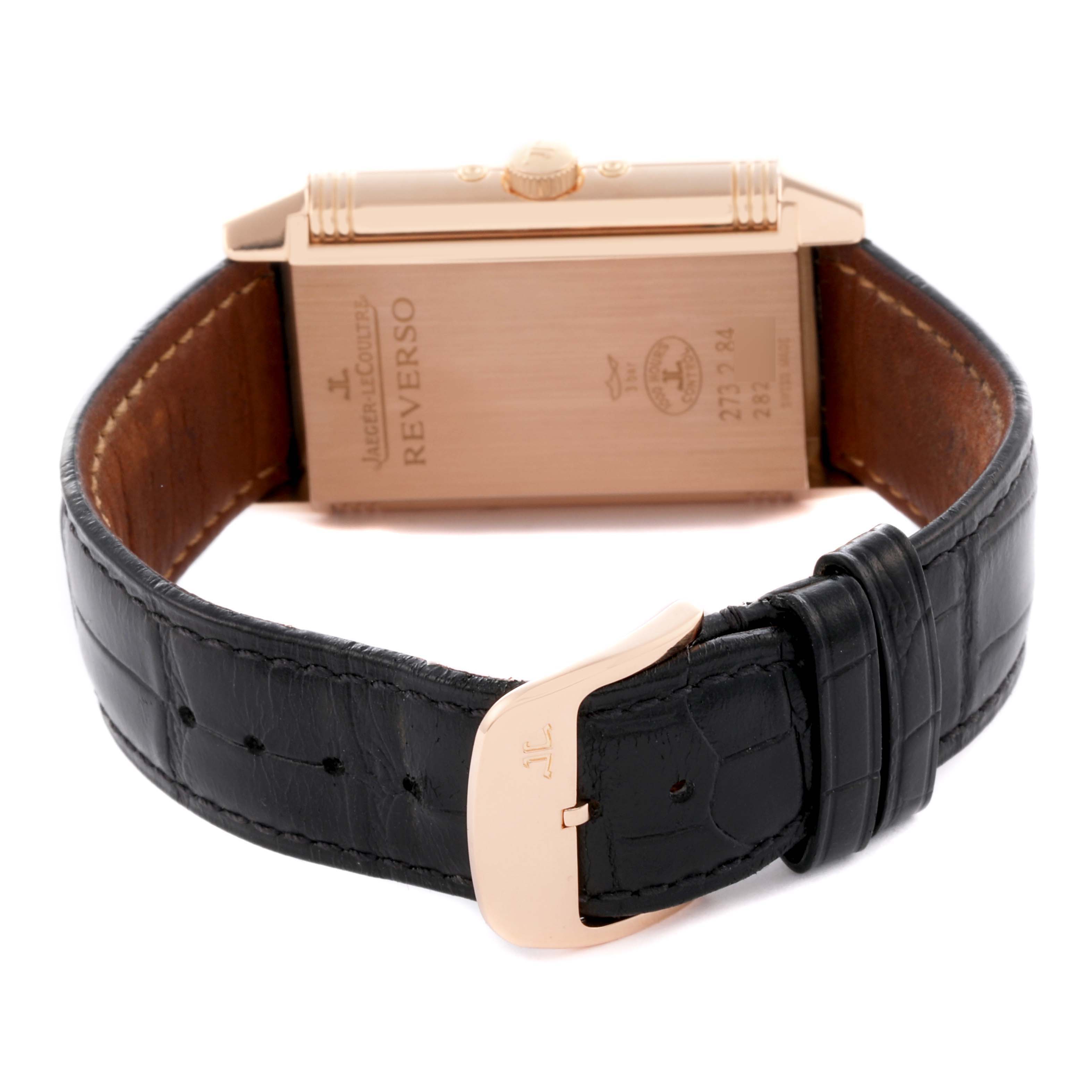 The image shows the back of the Jaeger LeCoultre Reverso Q3752520 Men's Rose Gold Silver Dial Q3752520 Men's Rose Gold Silver Dial watch at an angle, highlighting the case back and leather strap with buckle.