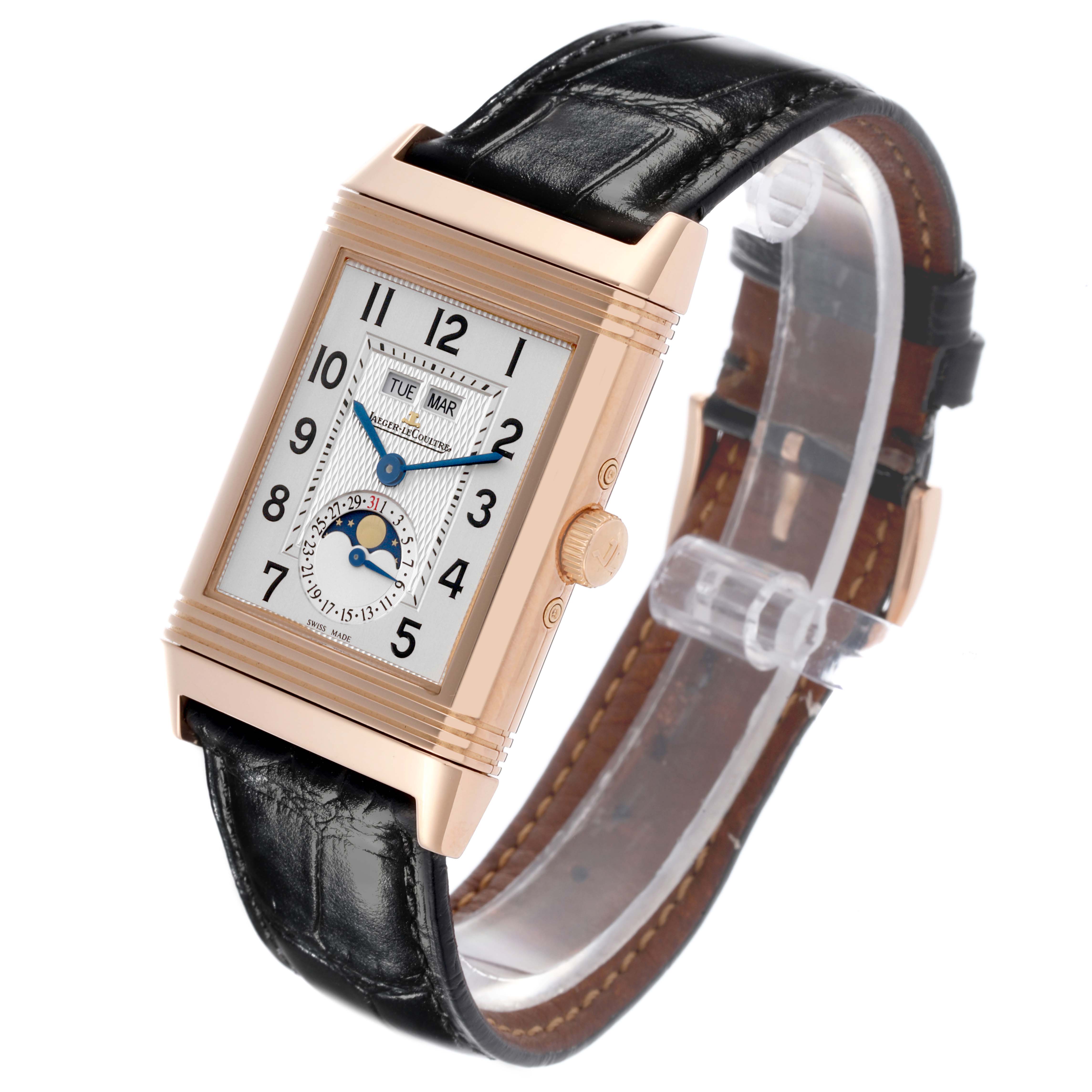 The Jaeger-LeCoultre Reverso watch is shown at a slight angle, displaying the face, side crown, and leather strap.