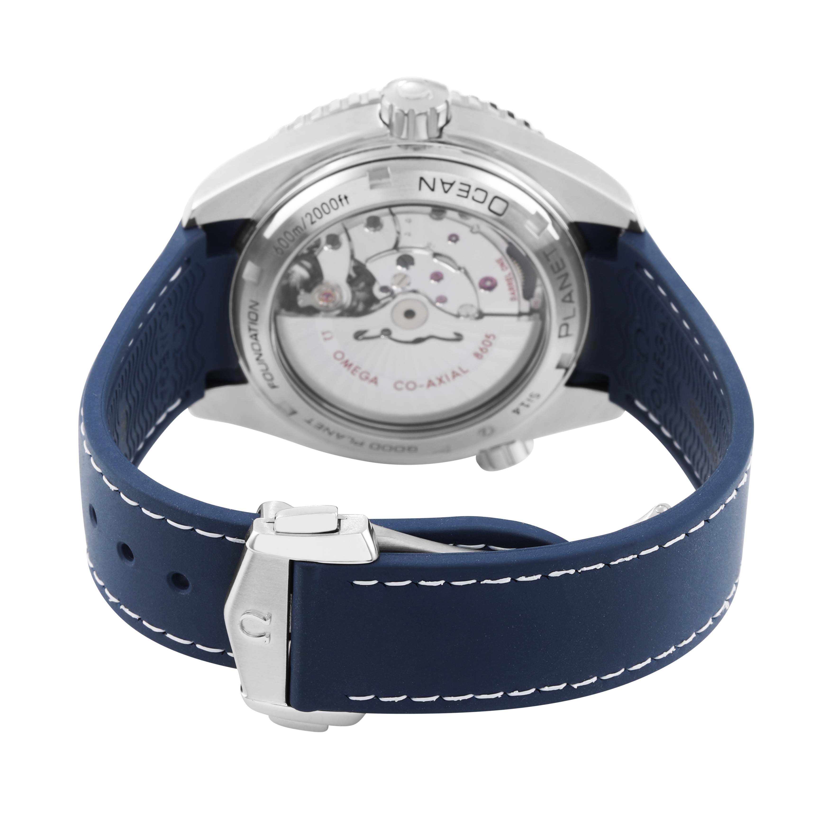 The Omega Seamaster 232.32.44.22.03.001 Men's Stainless Steel Blue Dial watch is shown from the back, displaying its transparent case back and blue strap with a clasp.
