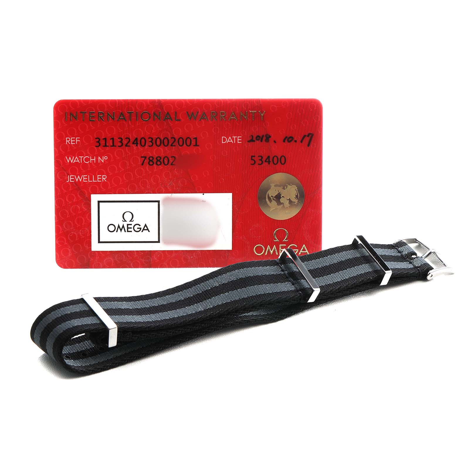 The image shows an Omega Speedmaster 311.32.40.30.02.001 Men's Stainless Steel Silver Dial's warranty card and a black and gray NATO strap with silver hardware.