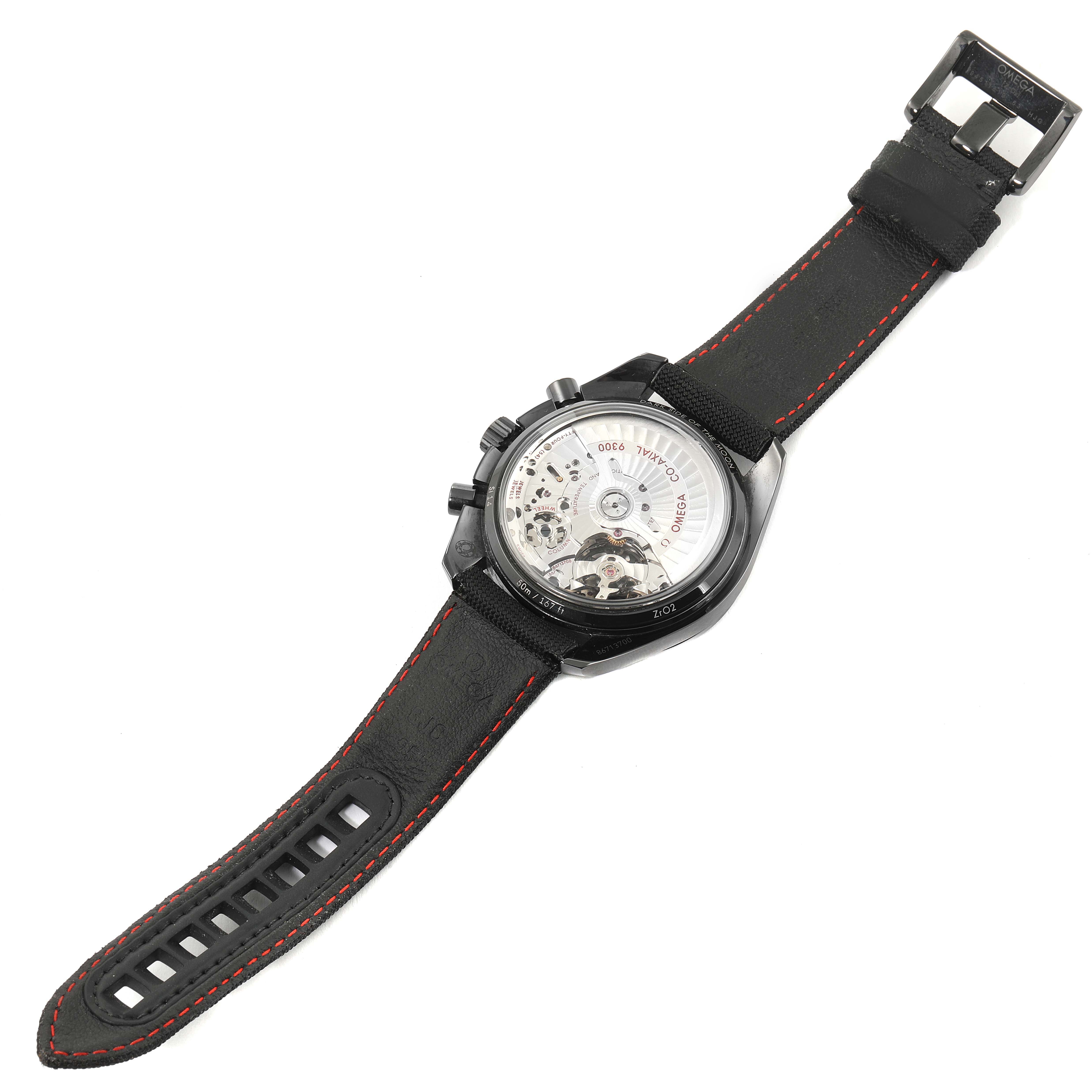 The image shows the back view of an Omega Speedmaster 311.92.44.51.01.003 Men's Ceramic Black Dial 311.92.44.51.01.003 Men's Ceramic Black Dial watch, highlighting its transparent case back and black strap with red stitching.